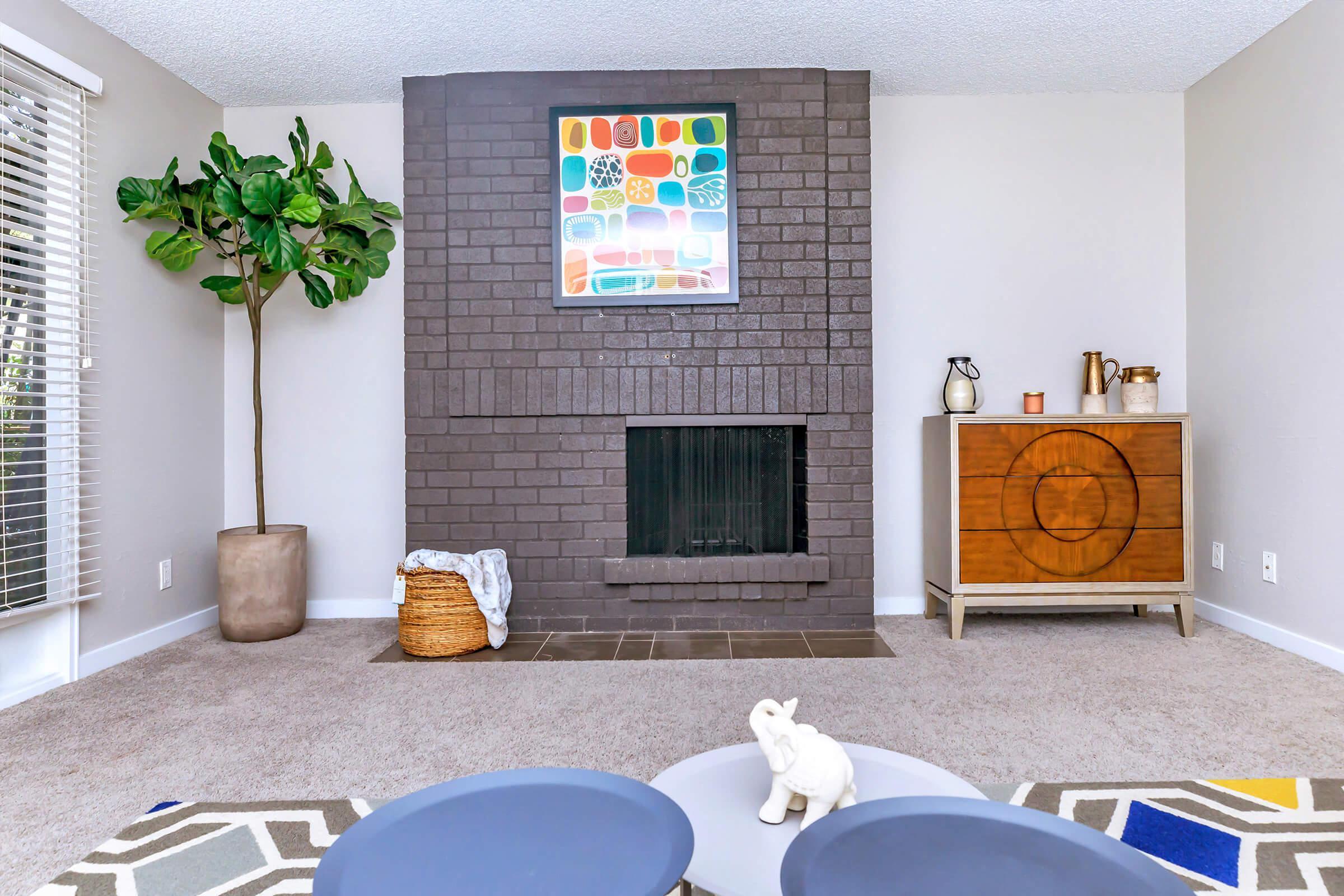 a living room with a fireplace and a table and chairs