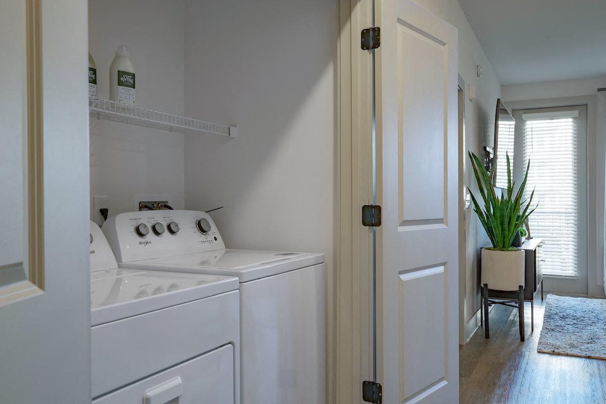 a white washer and dryer in a room with a white door