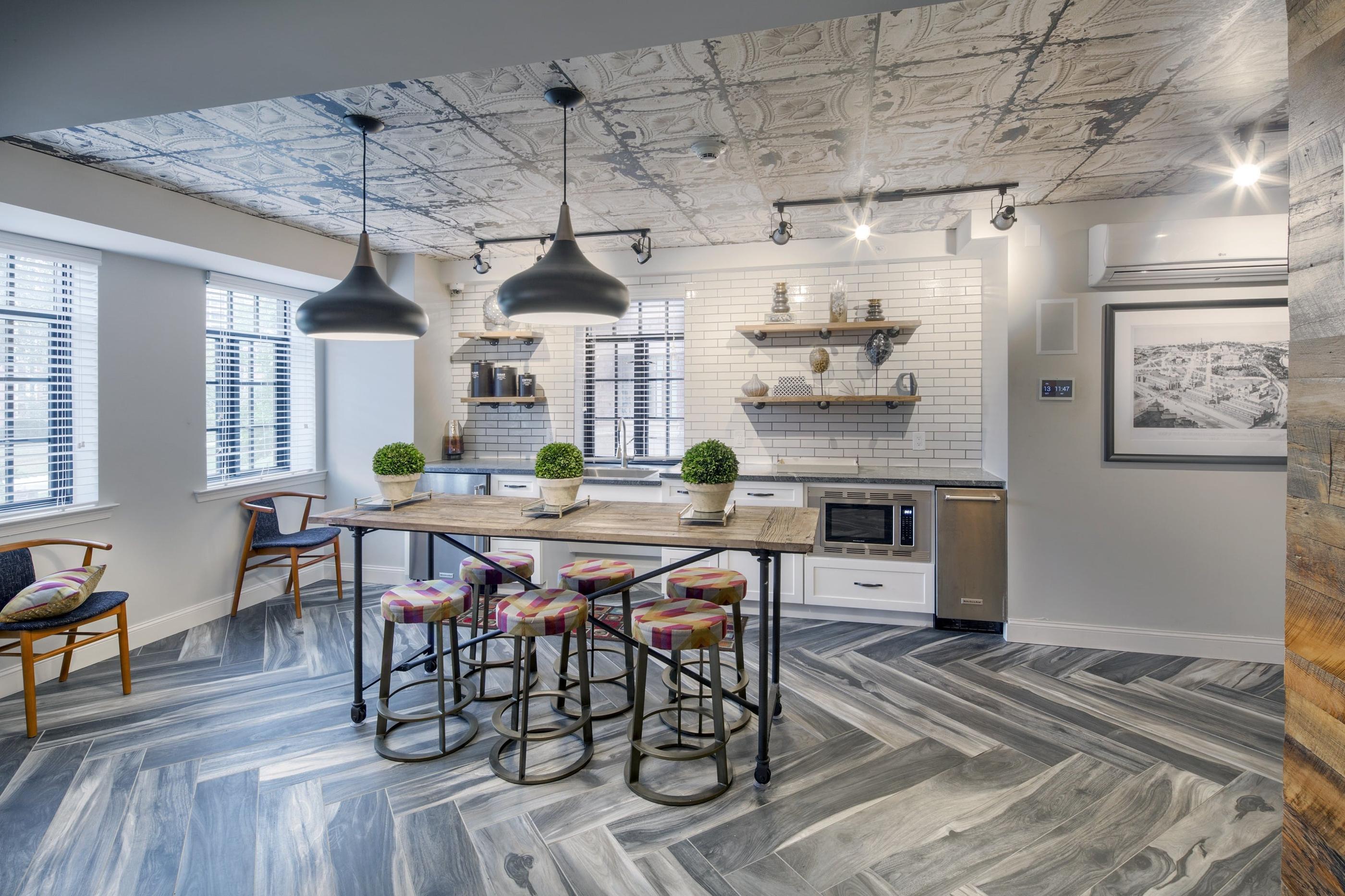 A kitchen with a table and chairs in the middle of the room.