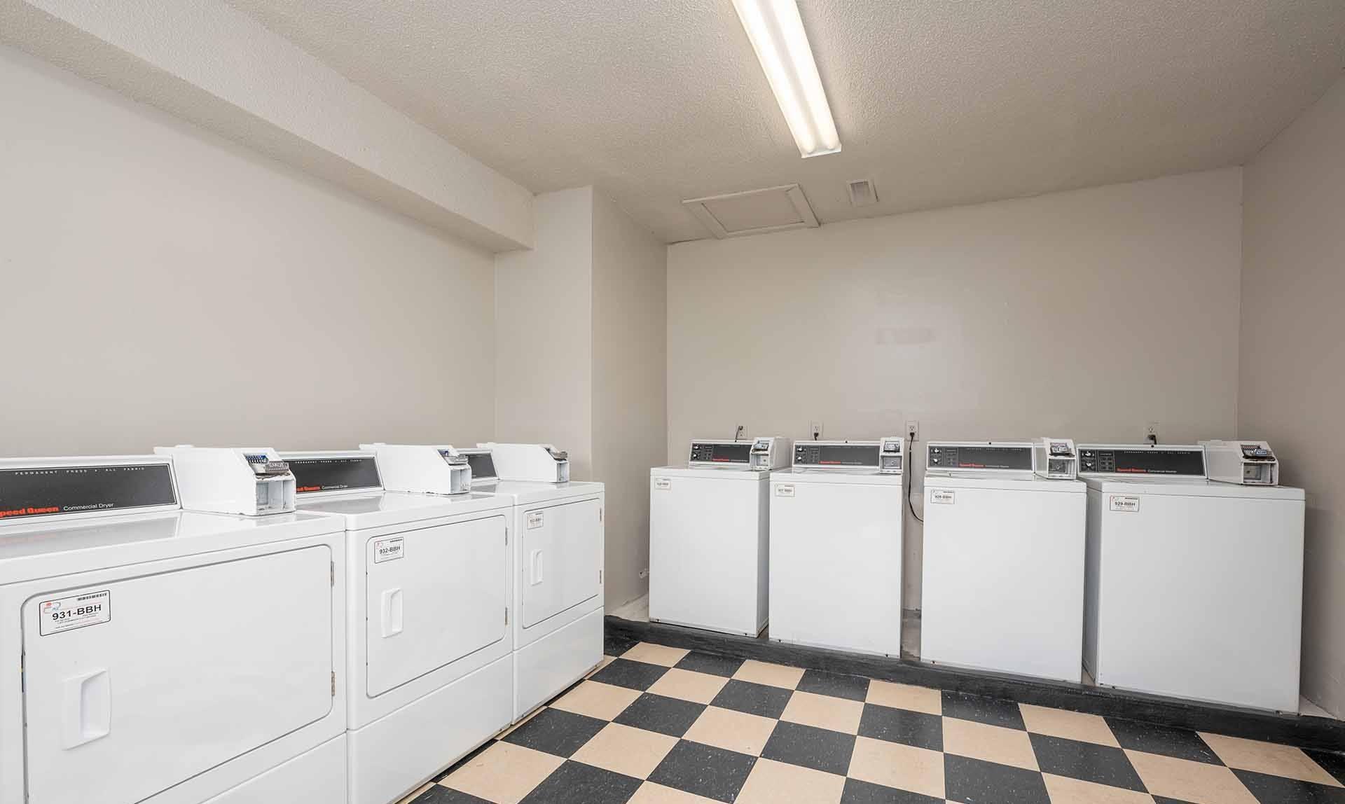 A row of washing machines in a laundromat.