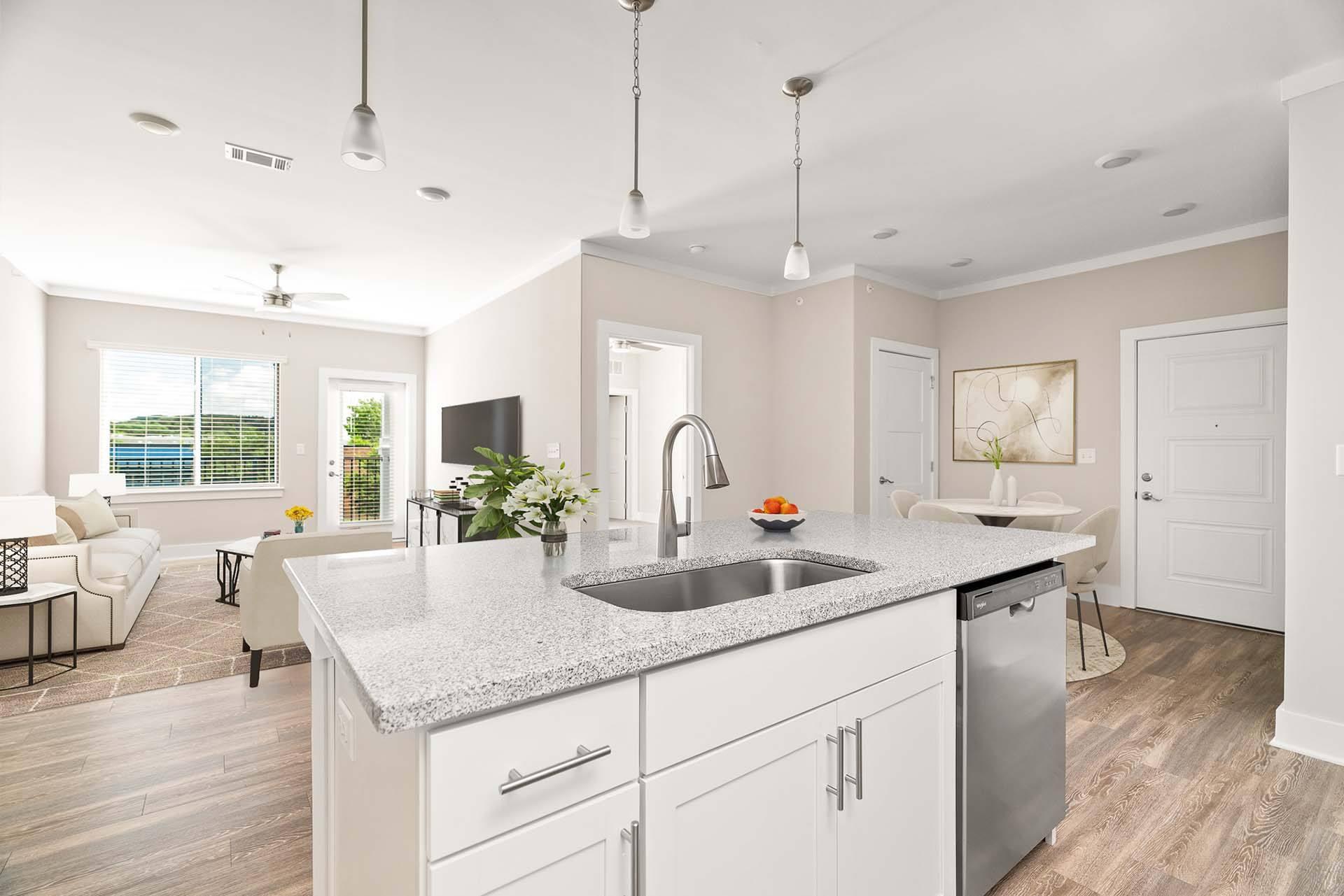 A modern kitchen with a large island and stainless steel appliances.