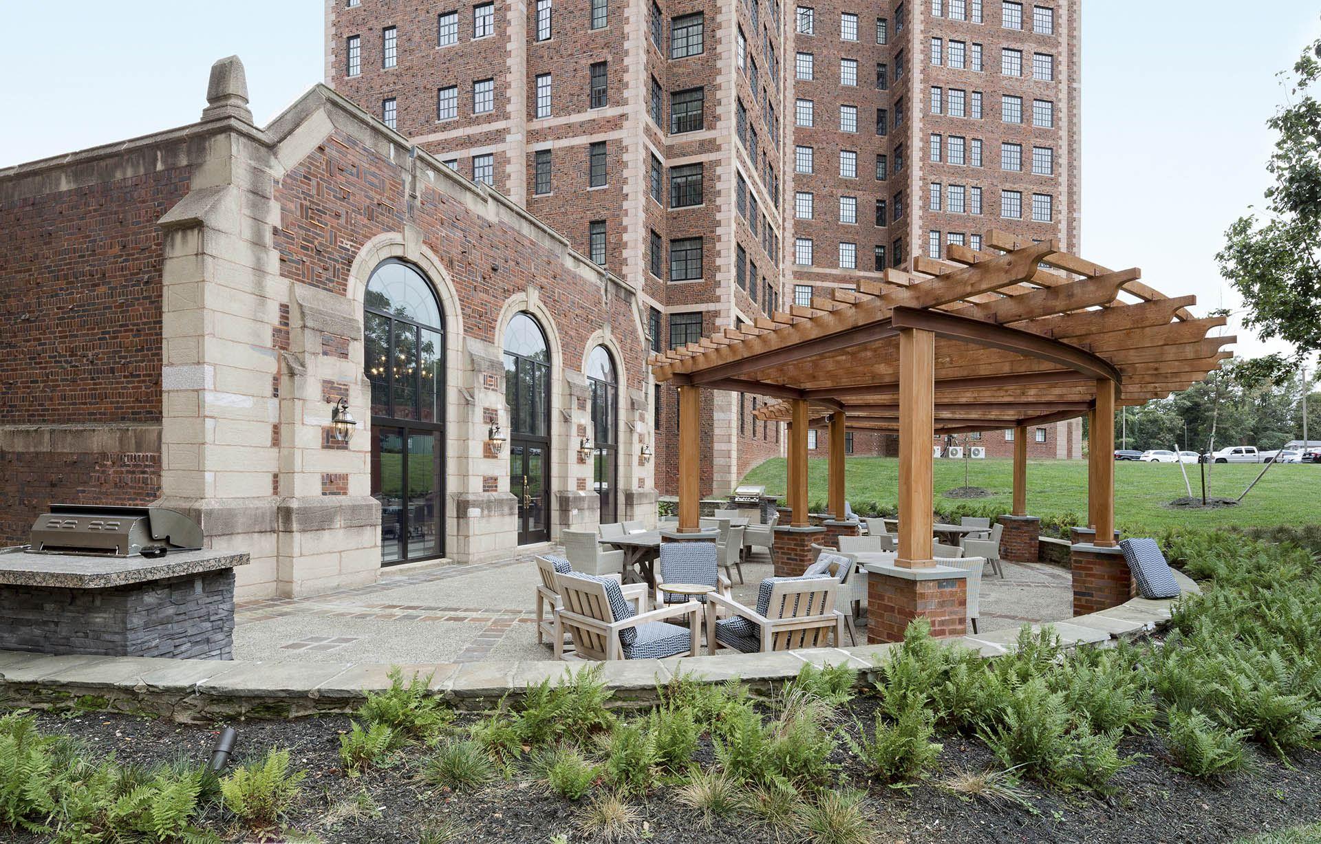A gazebo sits in the middle of a brick patio.