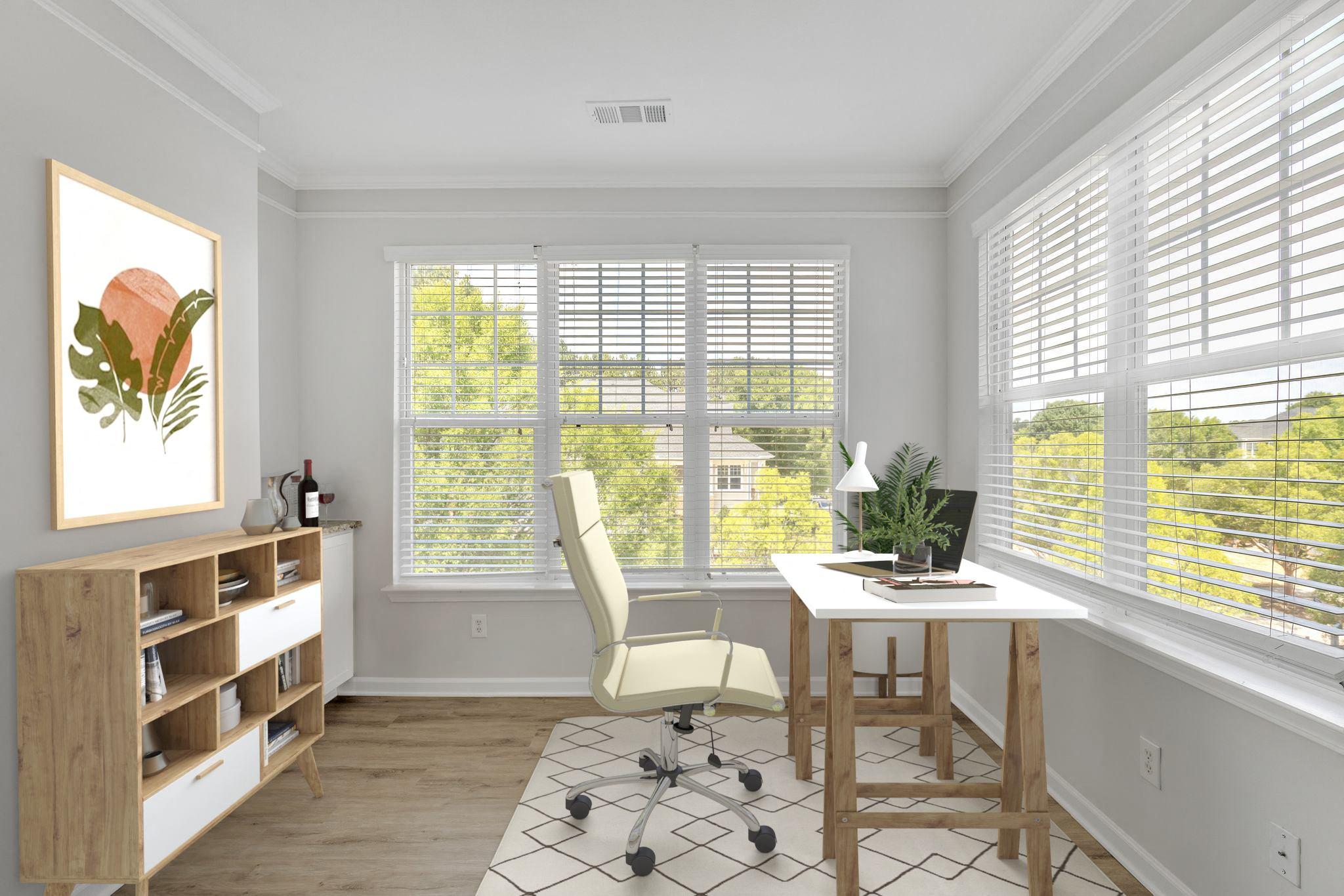 A room with a desk, chair, and a painting on the wall.