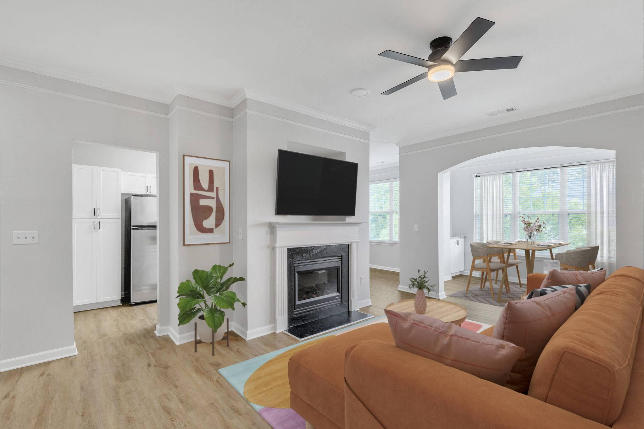 A living room with a brown couch and a fireplace.