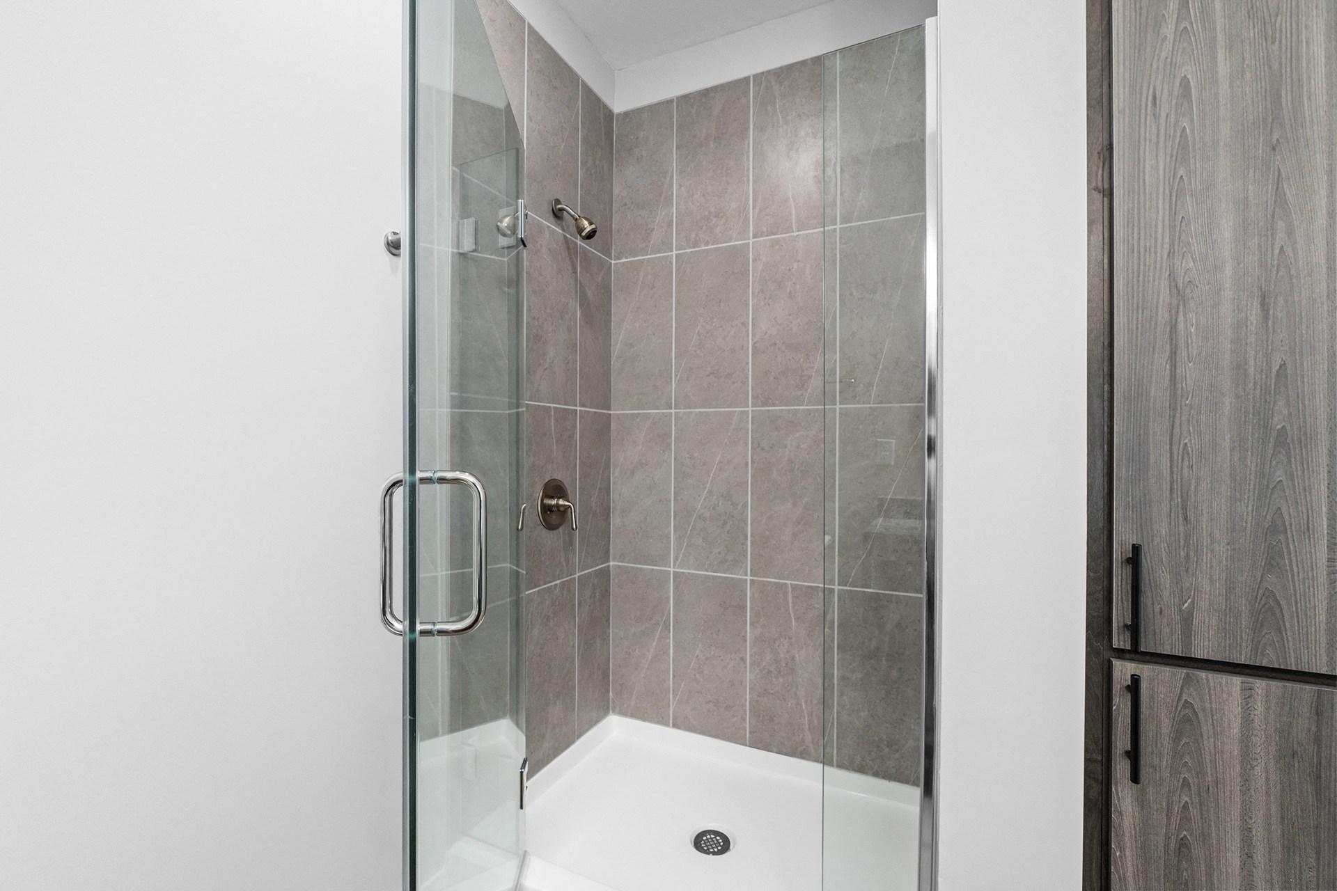 A modern bathroom with a walk-in shower.