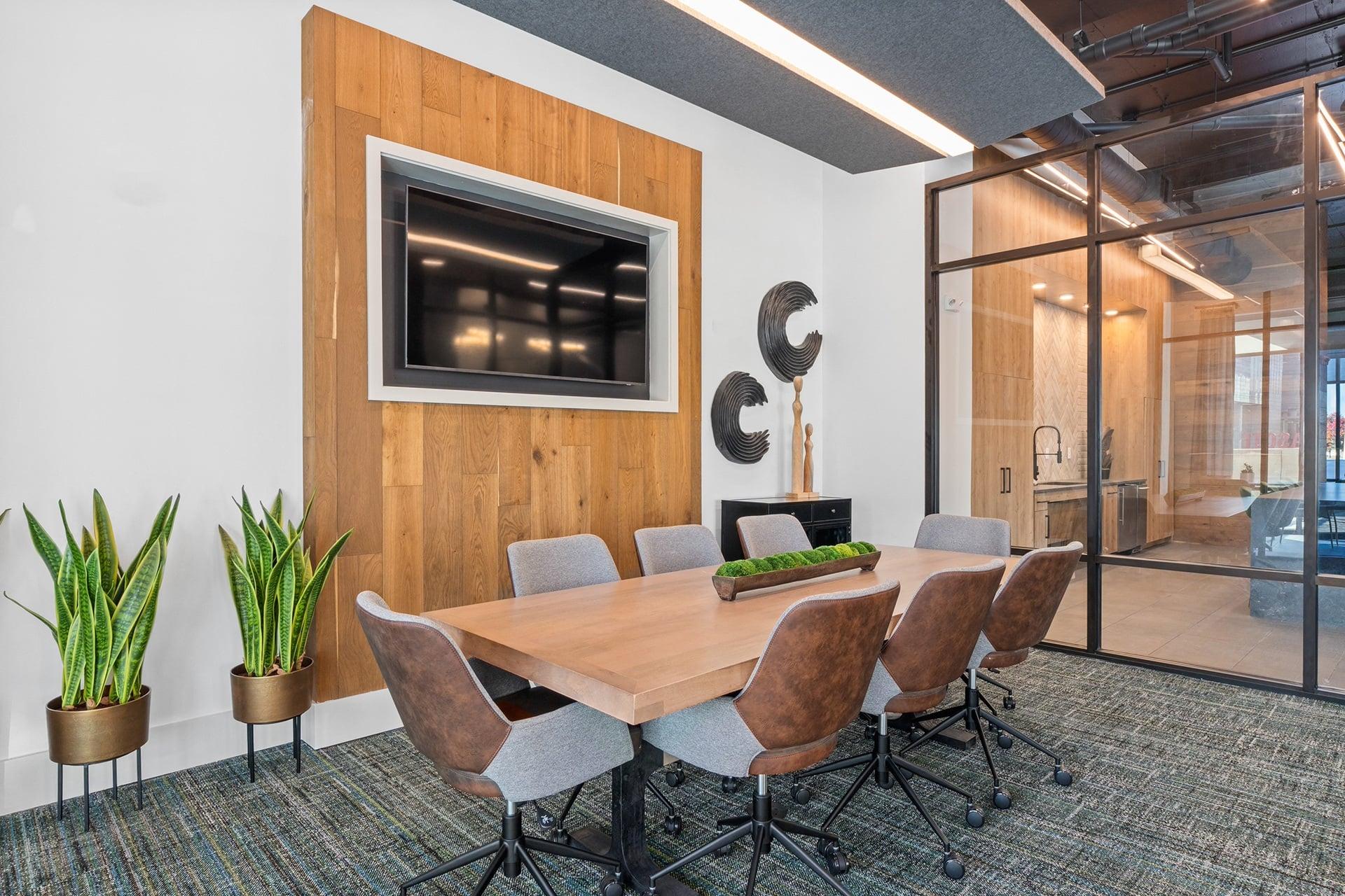 A conference room with a wooden table and chairs.