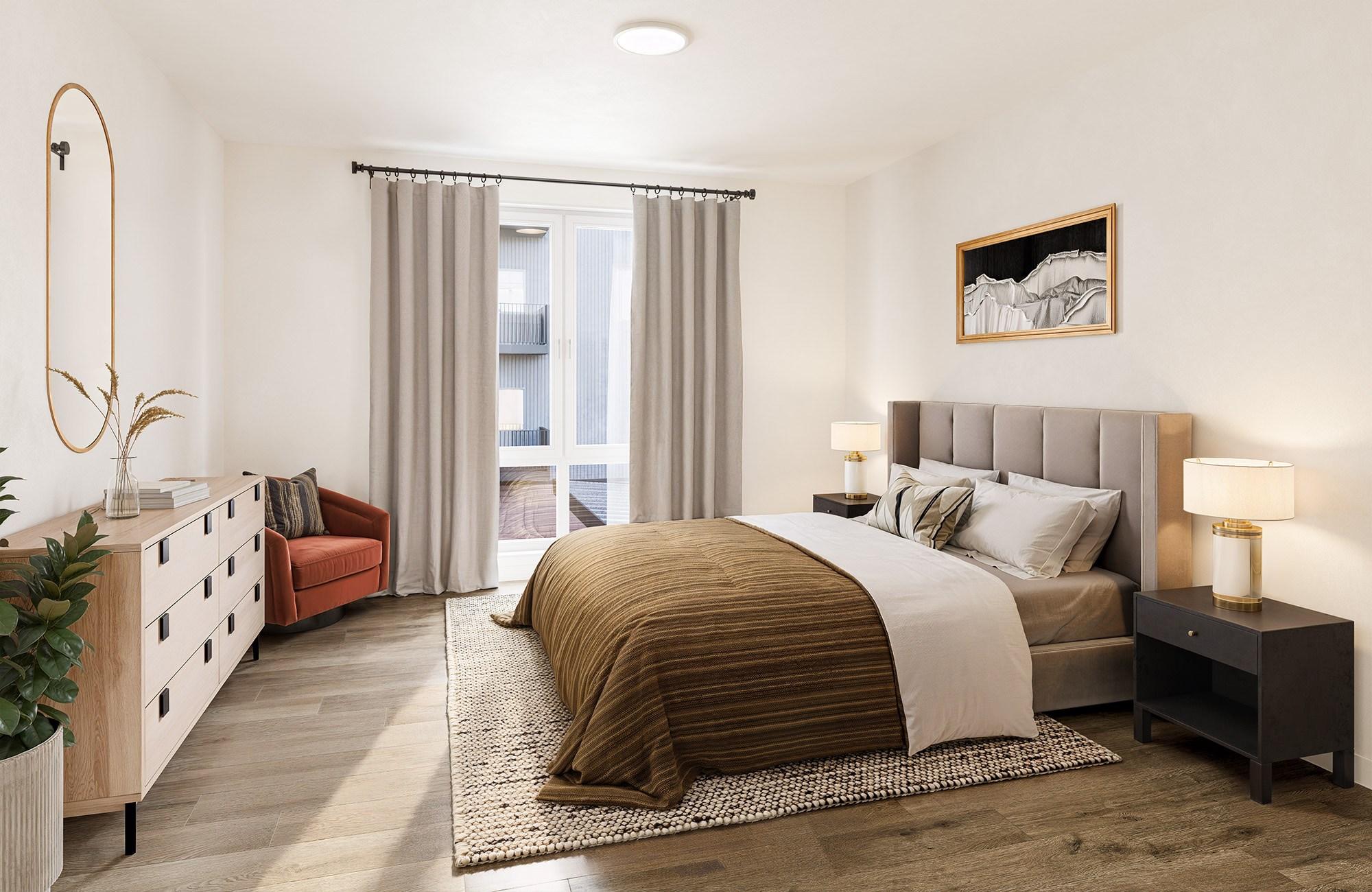 A bedroom with a large bed and a red chair.