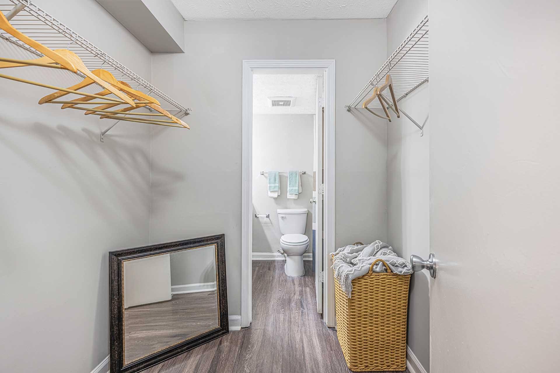 A bathroom with a toilet, sink, and a mirror.