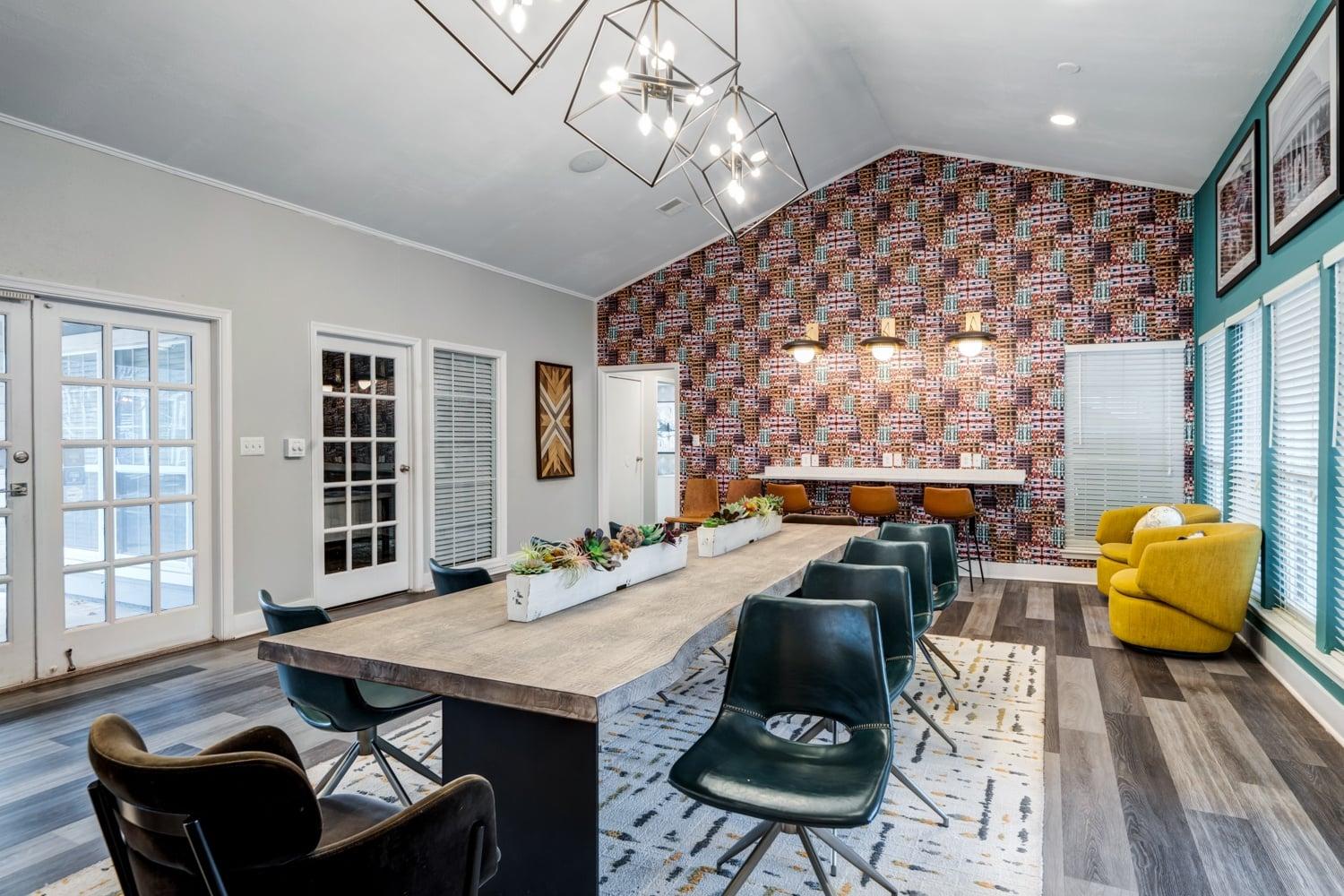 A dining room with a long table and chairs.