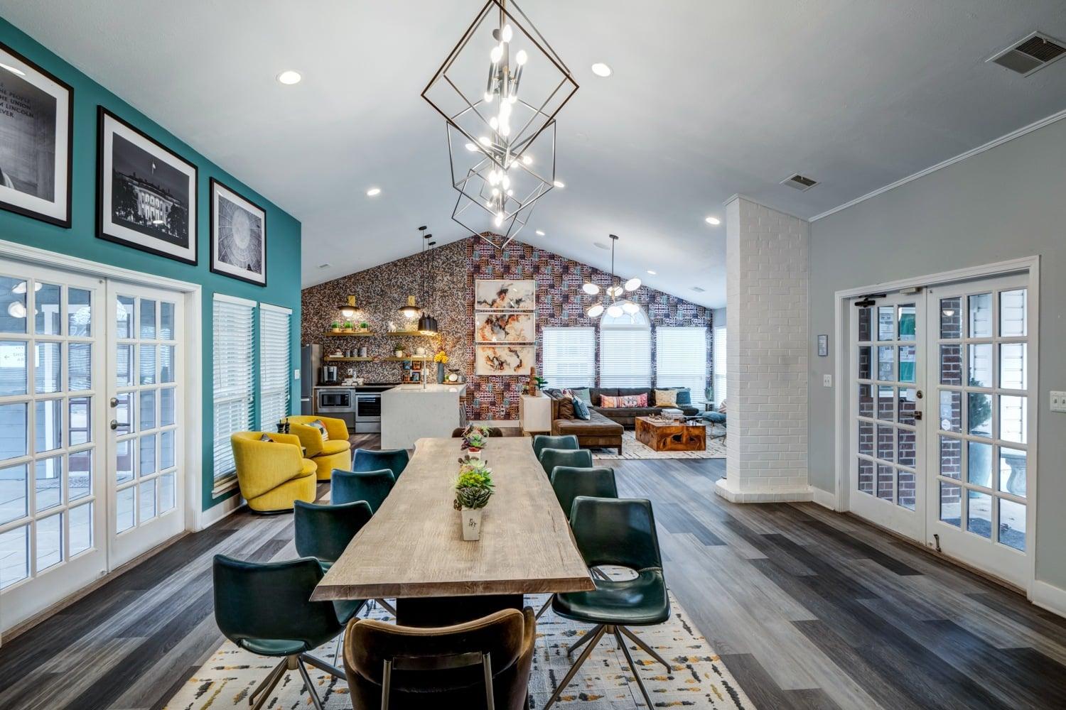 A dining room with a long table and chairs.