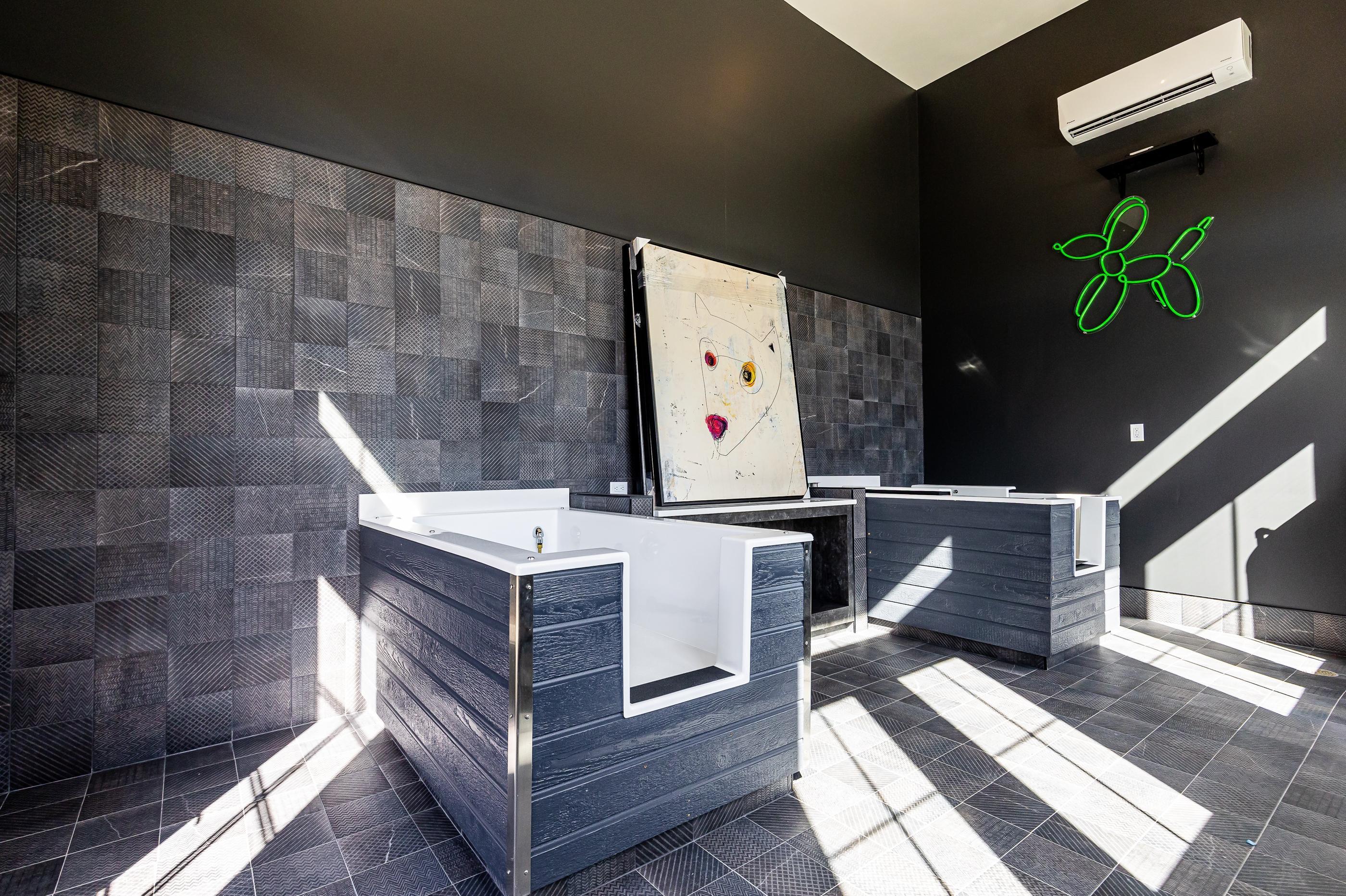 A modern bathroom with a large mirror and a white sink.