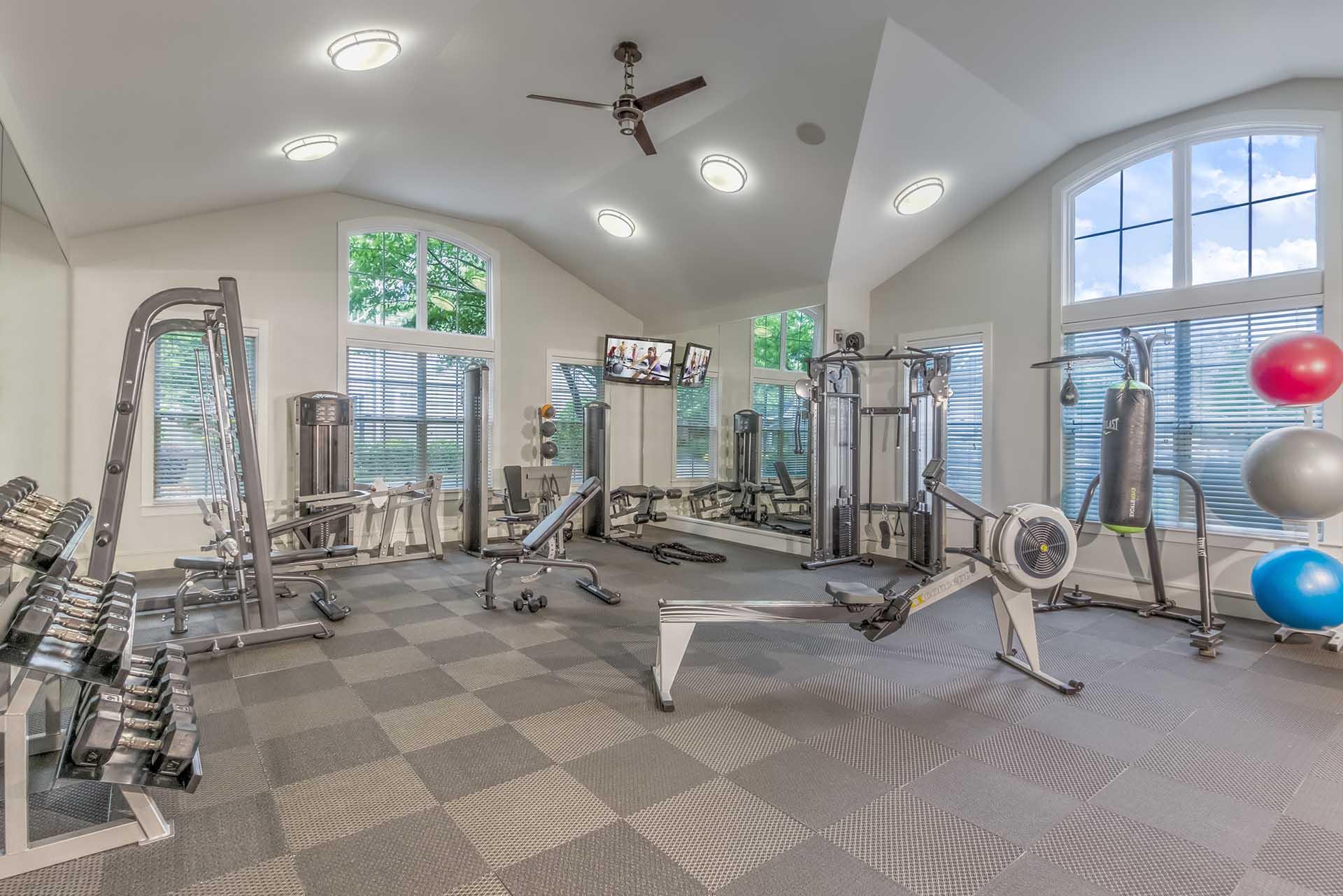 A spacious home gym with a variety of exercise equipment.