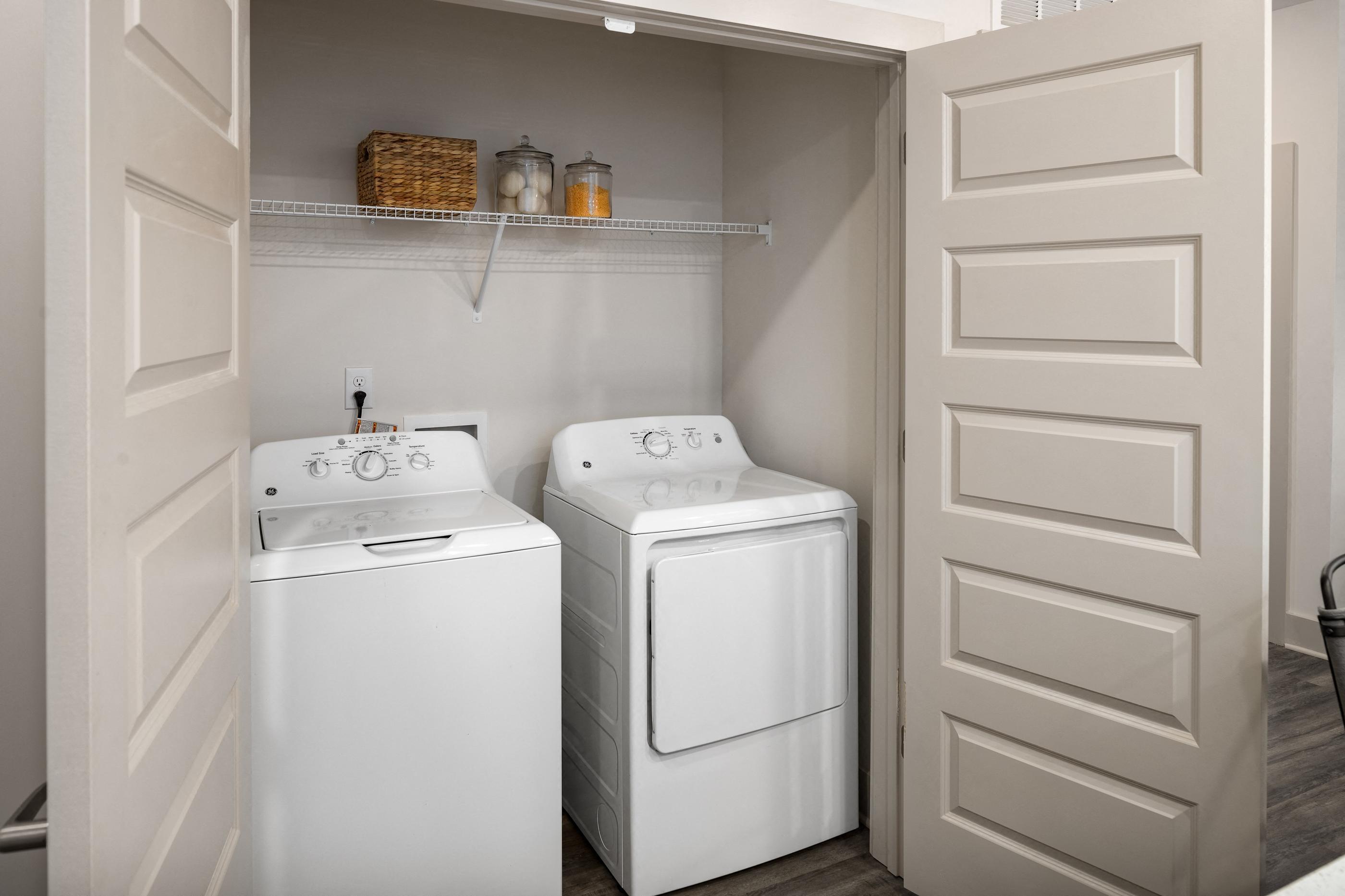 a small laundry room with two washes and a dryer