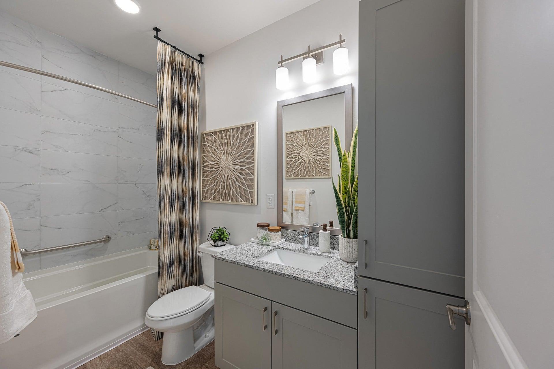 a bathroom with a shower and a toilet and a sink