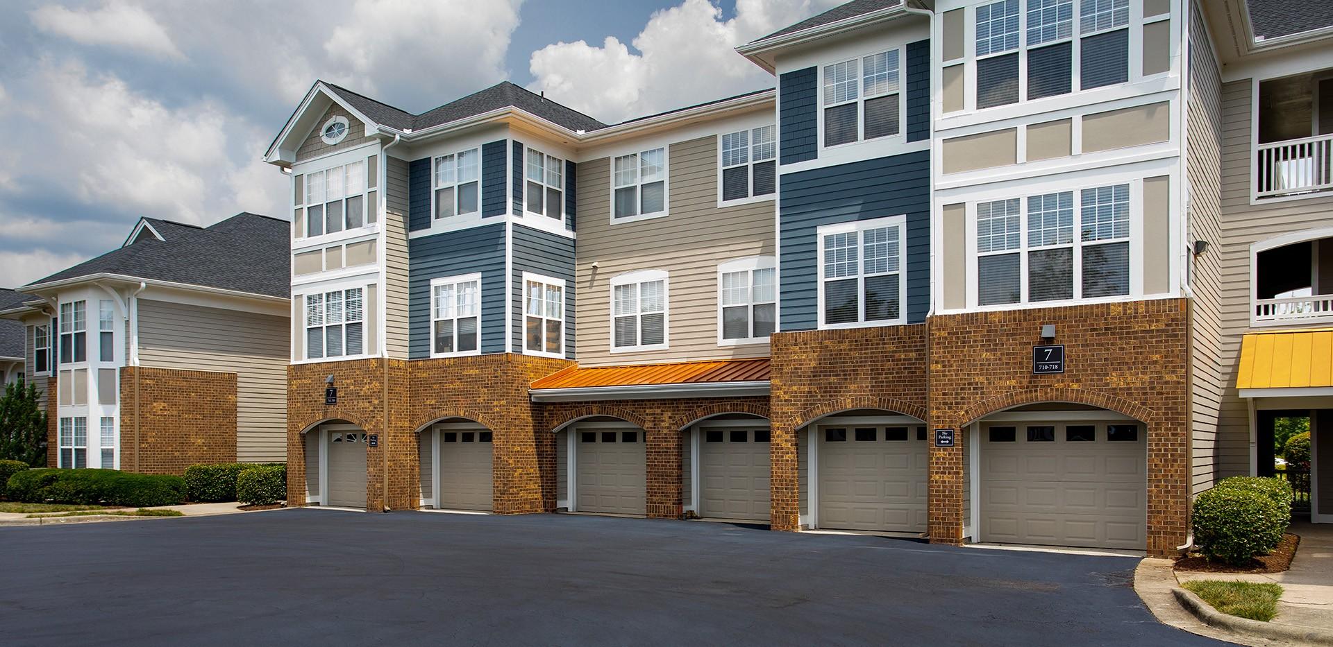 A large multi-story building with a garage on the ground floor.