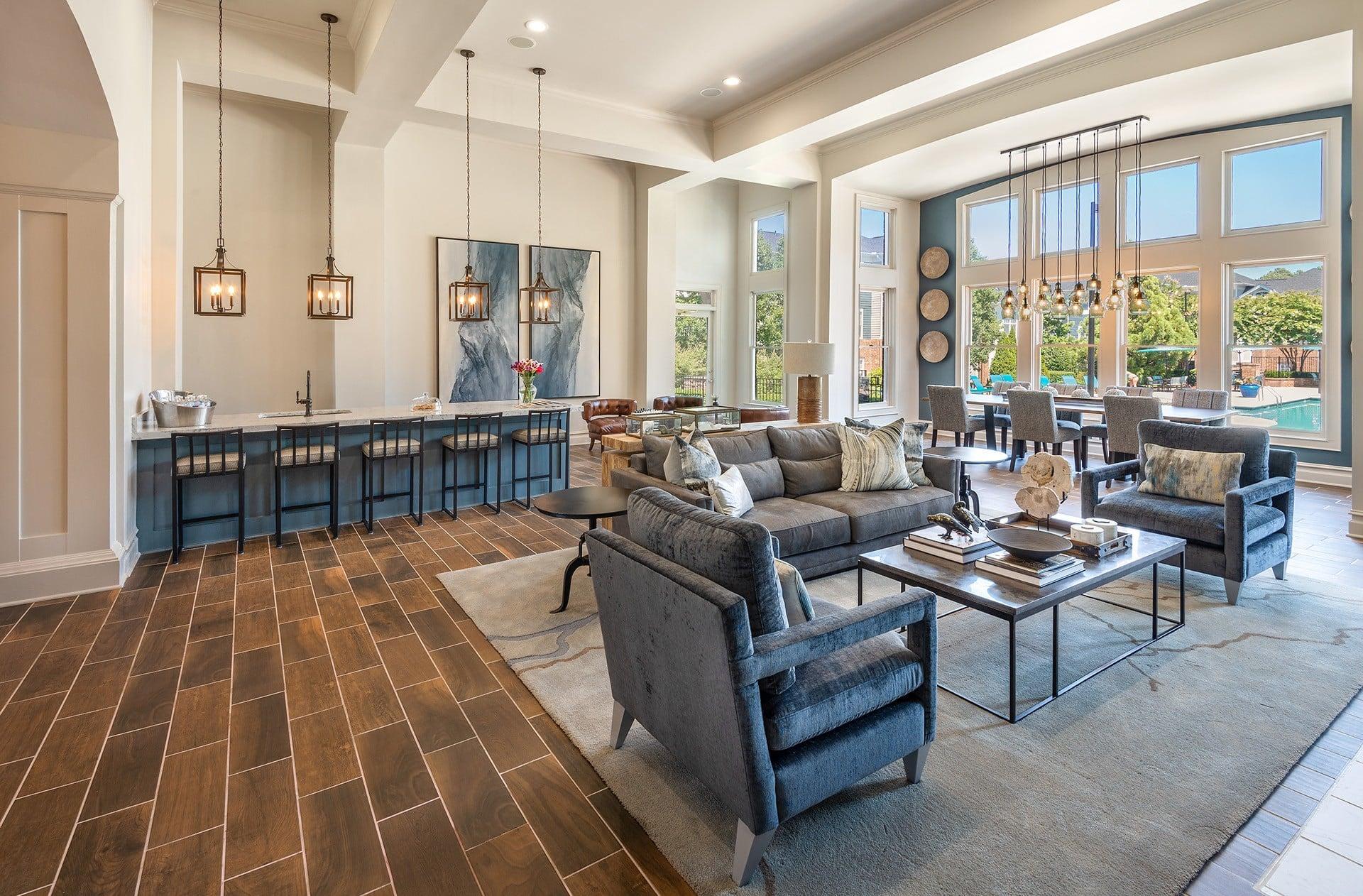 A modern living room with a dark wood floor and a large sectional sofa.