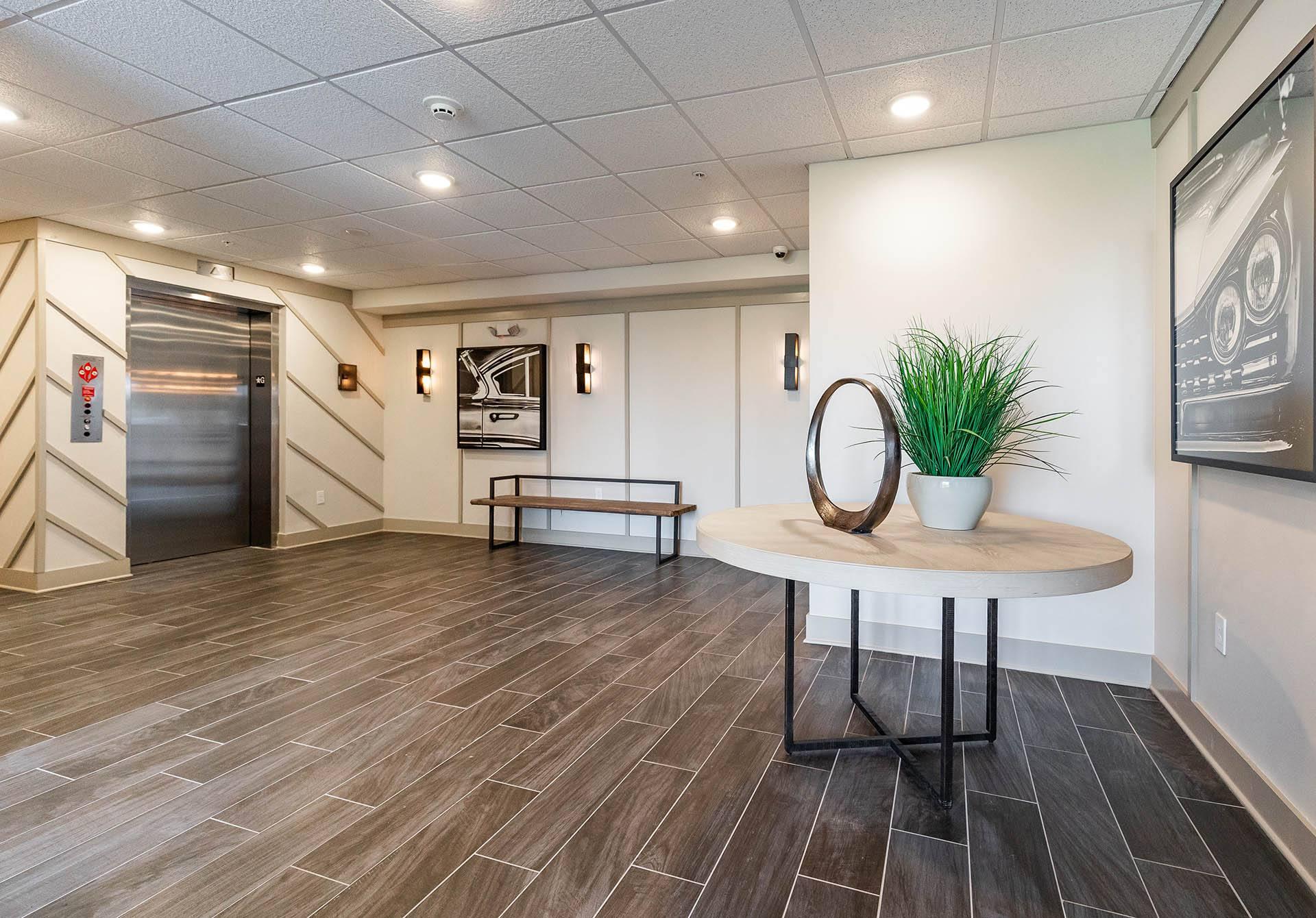 a lobby with a table and a hallway with a door