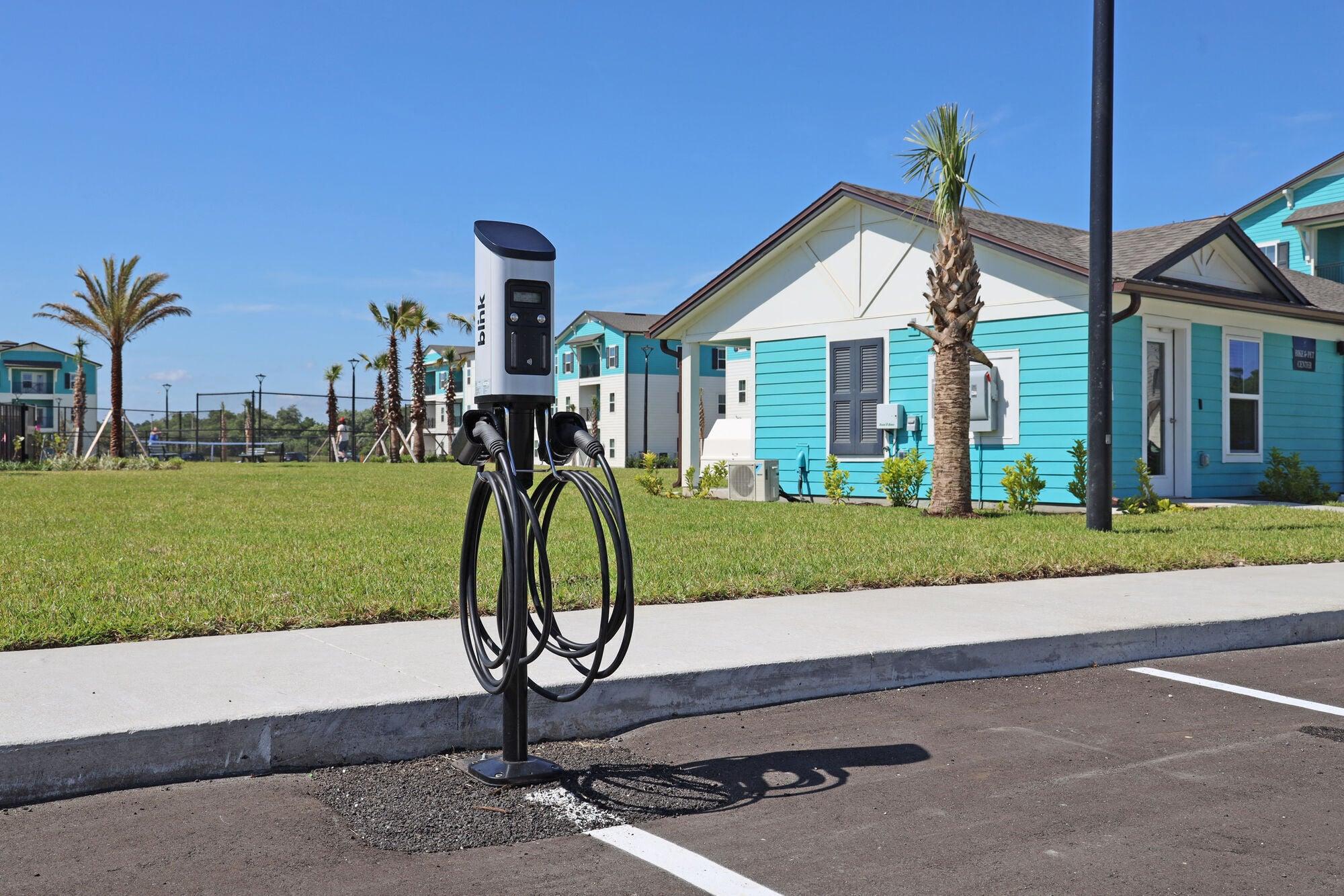 a parking meter in front of a blue house