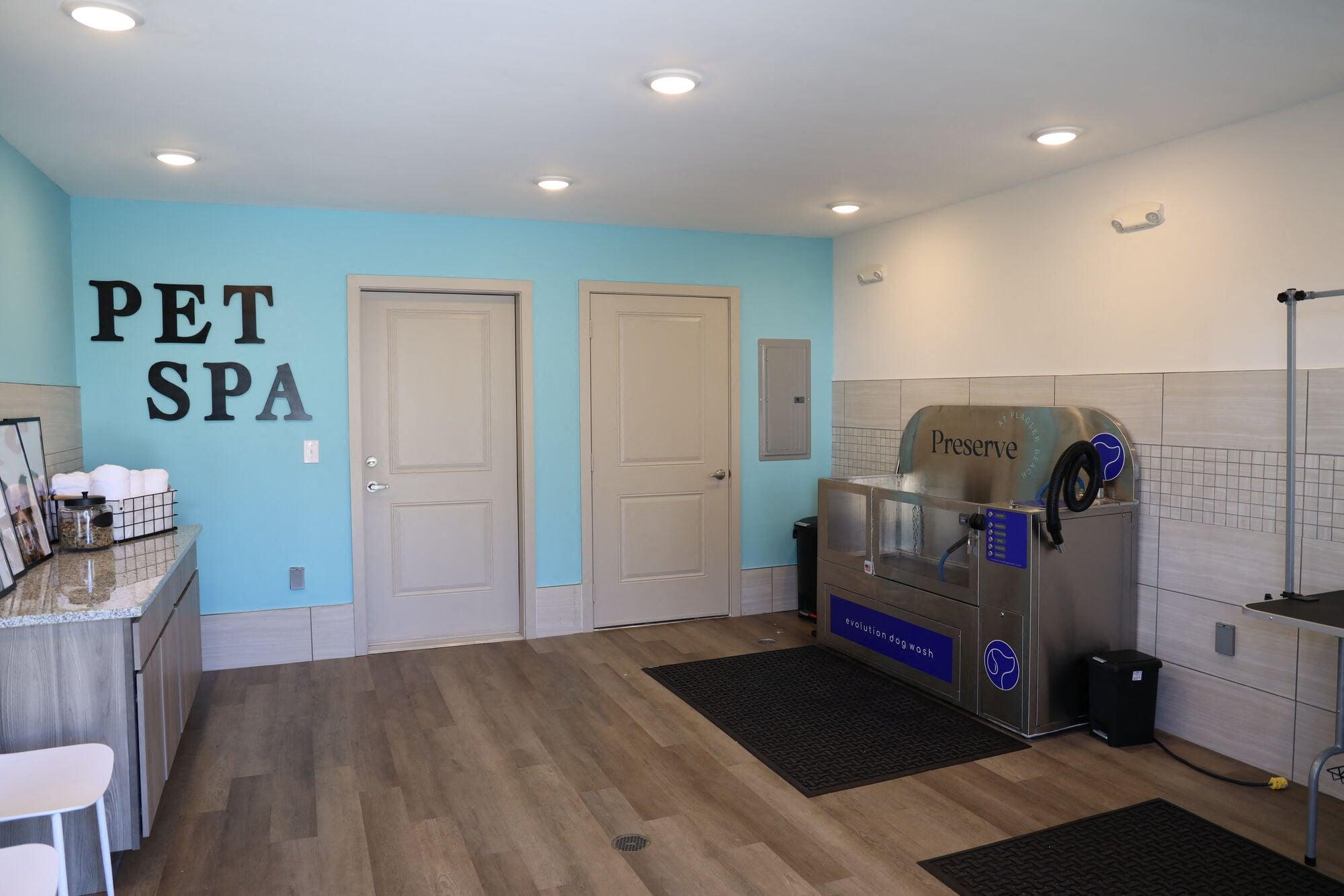 a pet spa room with a claw foot tub and a machine