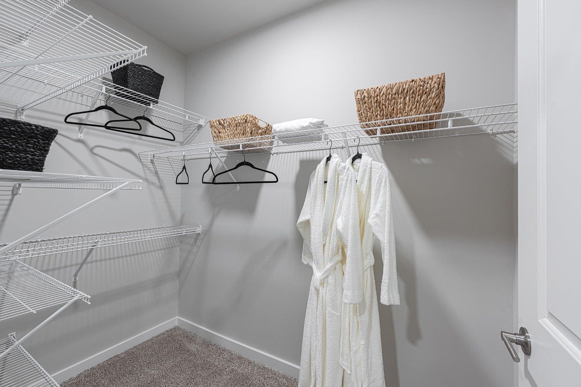 our spacious closets feature a spacious walk in closet with wire shelves and a spacious