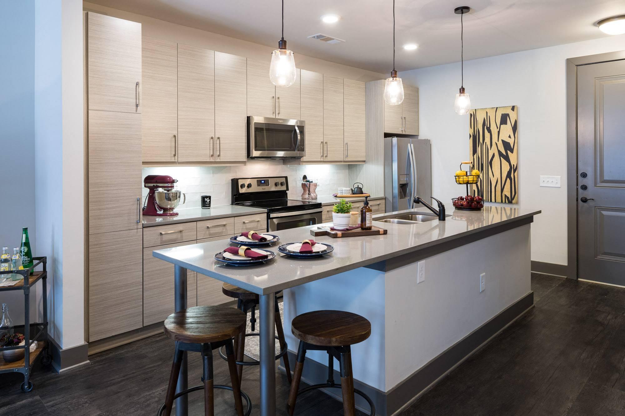A kitchen with a table and chairs and a refrigerator.