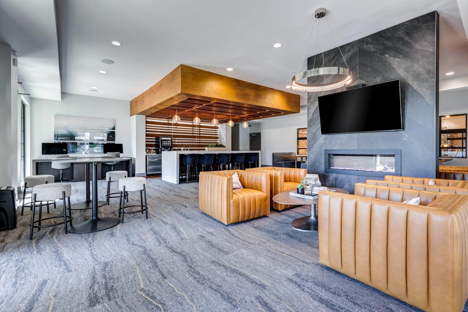 A modern living room with a large television and comfortable seating.