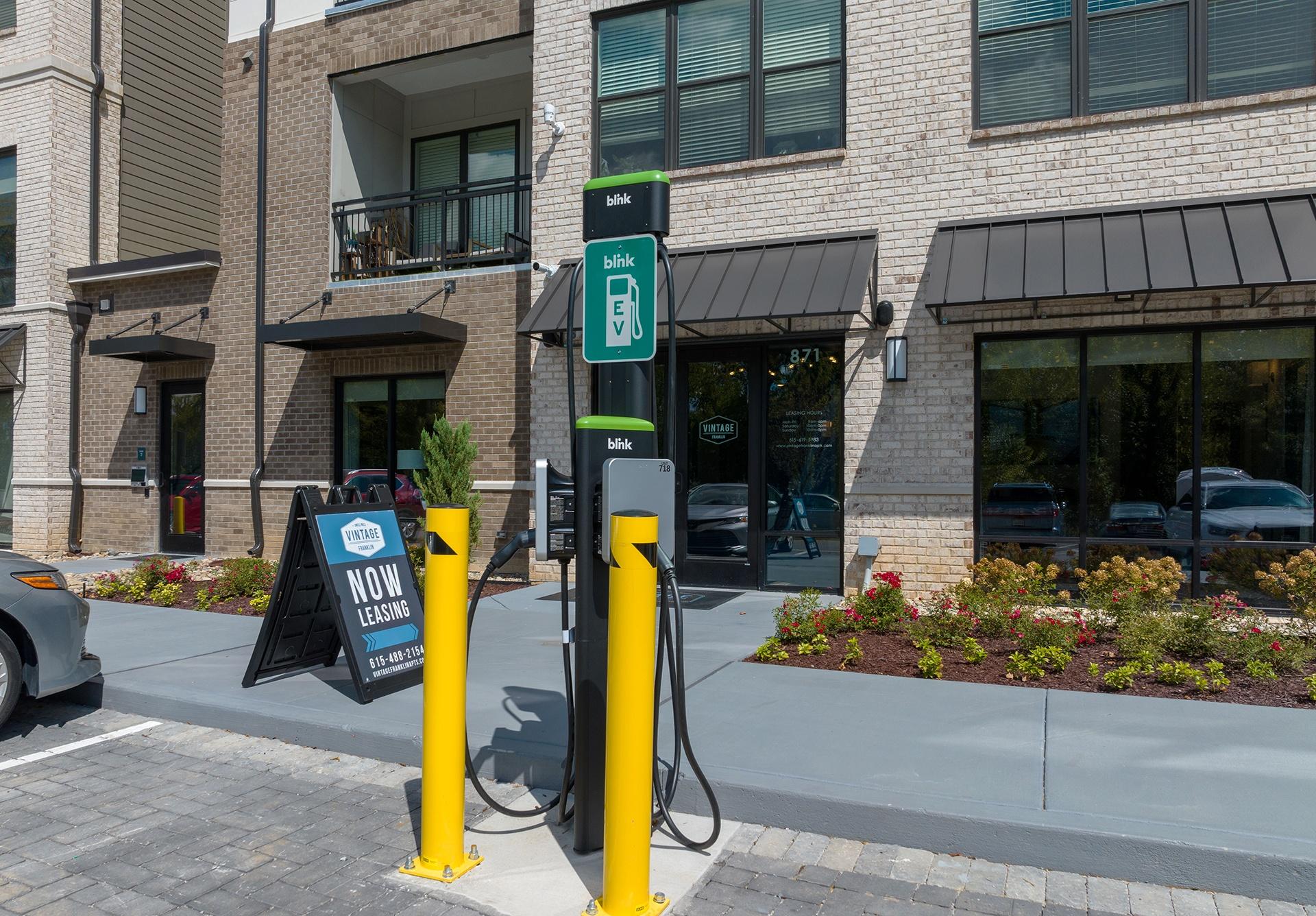 A charging station for electric vehicles is located outside a building.