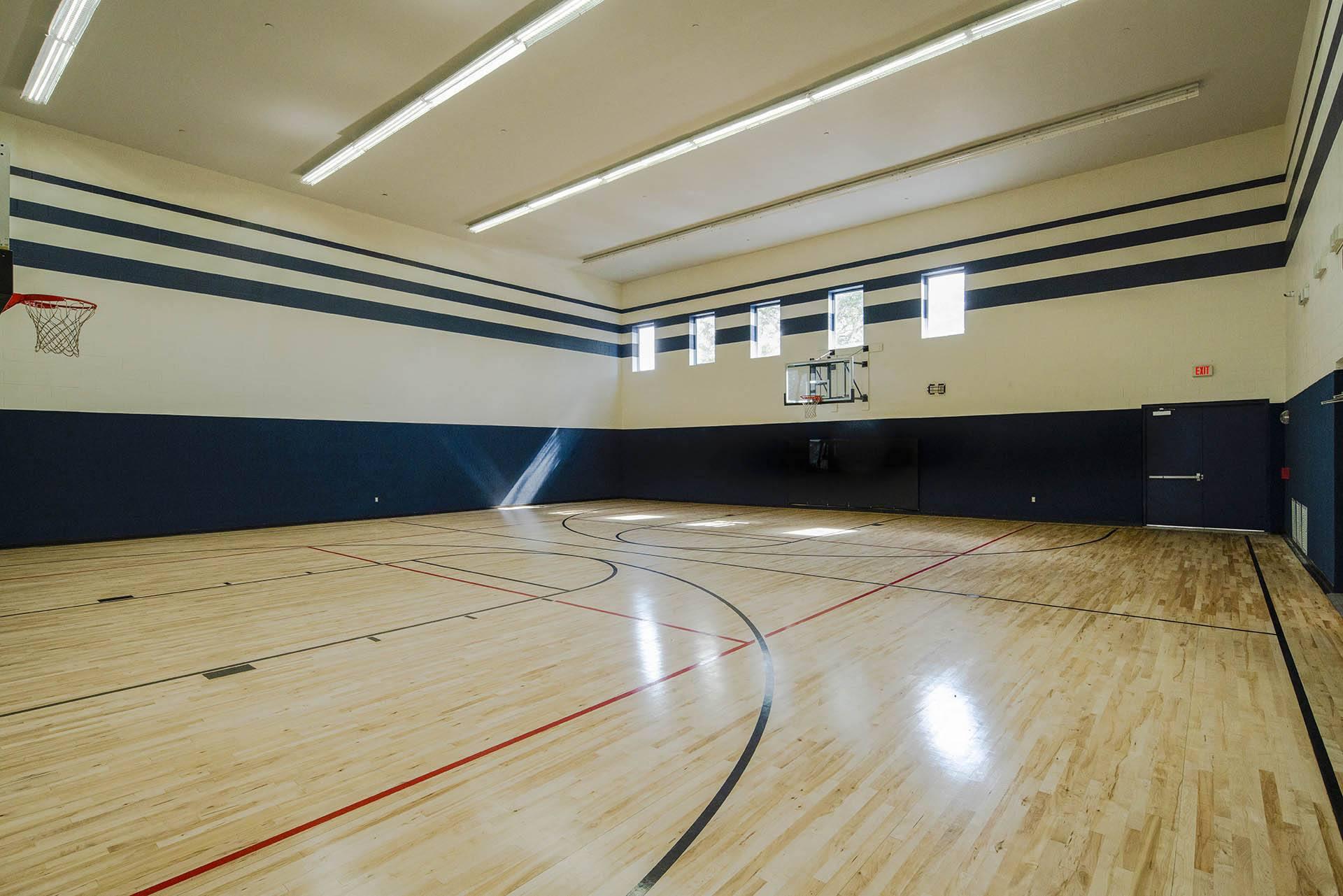 a basketball court in an empty gym with wood floors