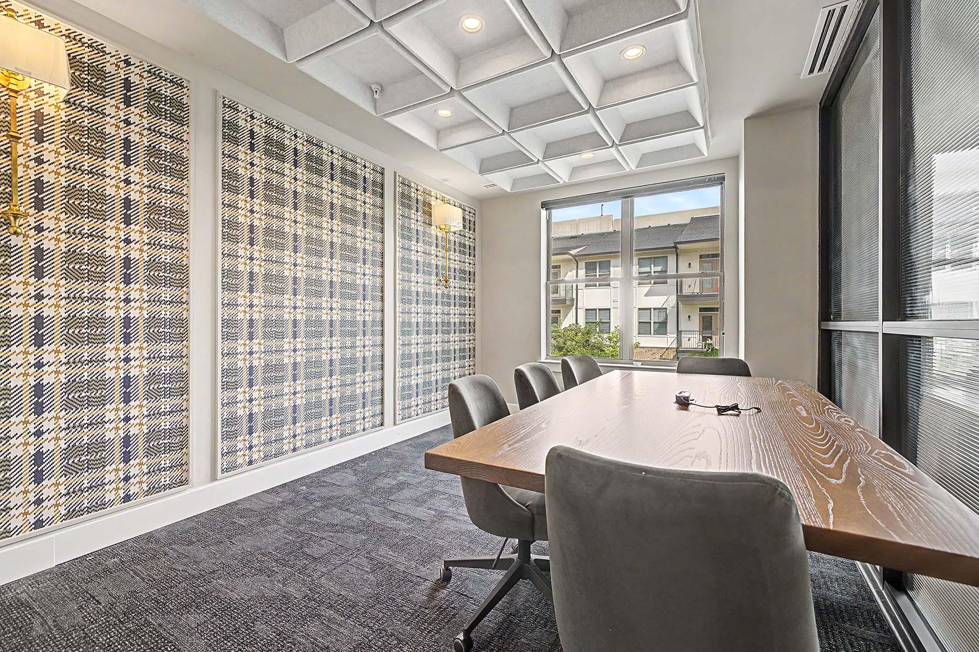 A conference room with a long table and chairs.