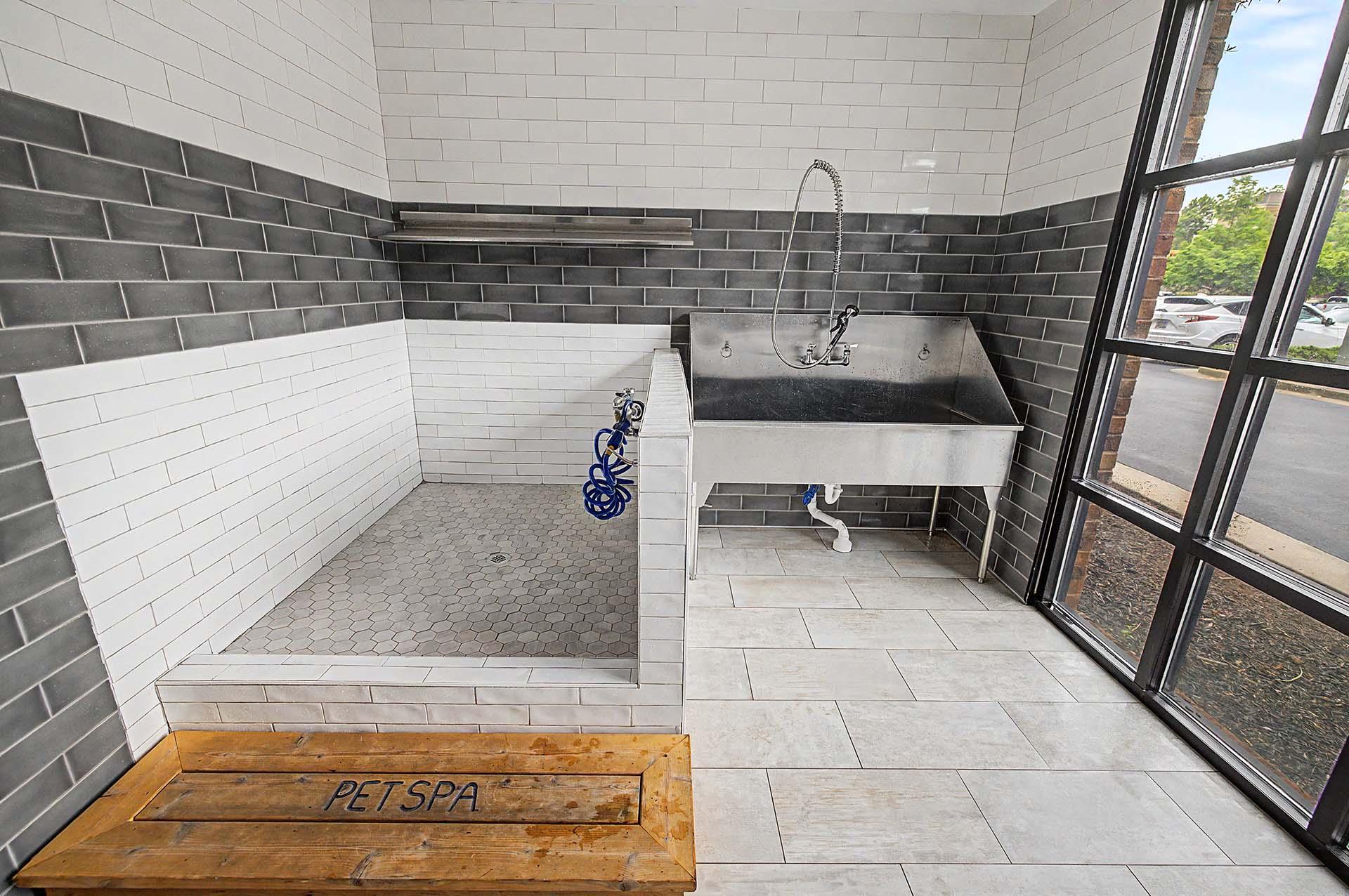 A bathroom with a sign that says "PET SPA" on the floor.