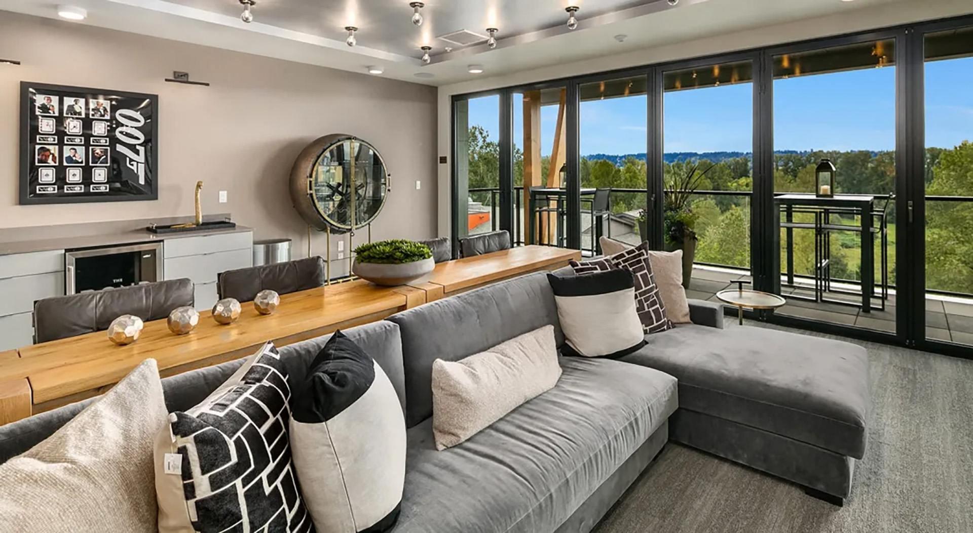 a living room with a gray couch and a large window