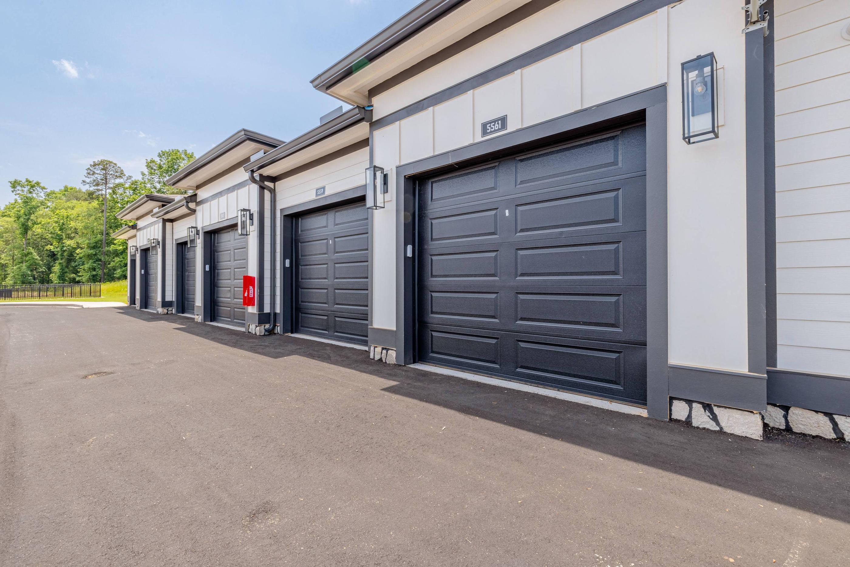A series of storage units with doors and windows are lined up in a row.