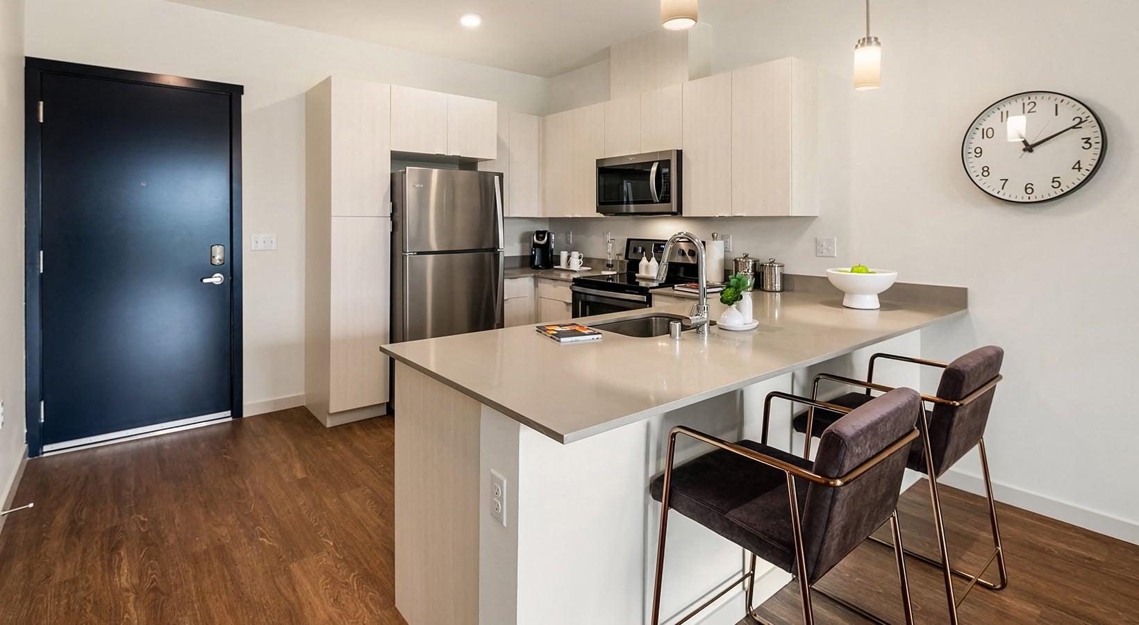 a kitchen with white cabinetry and stainless steel appliances