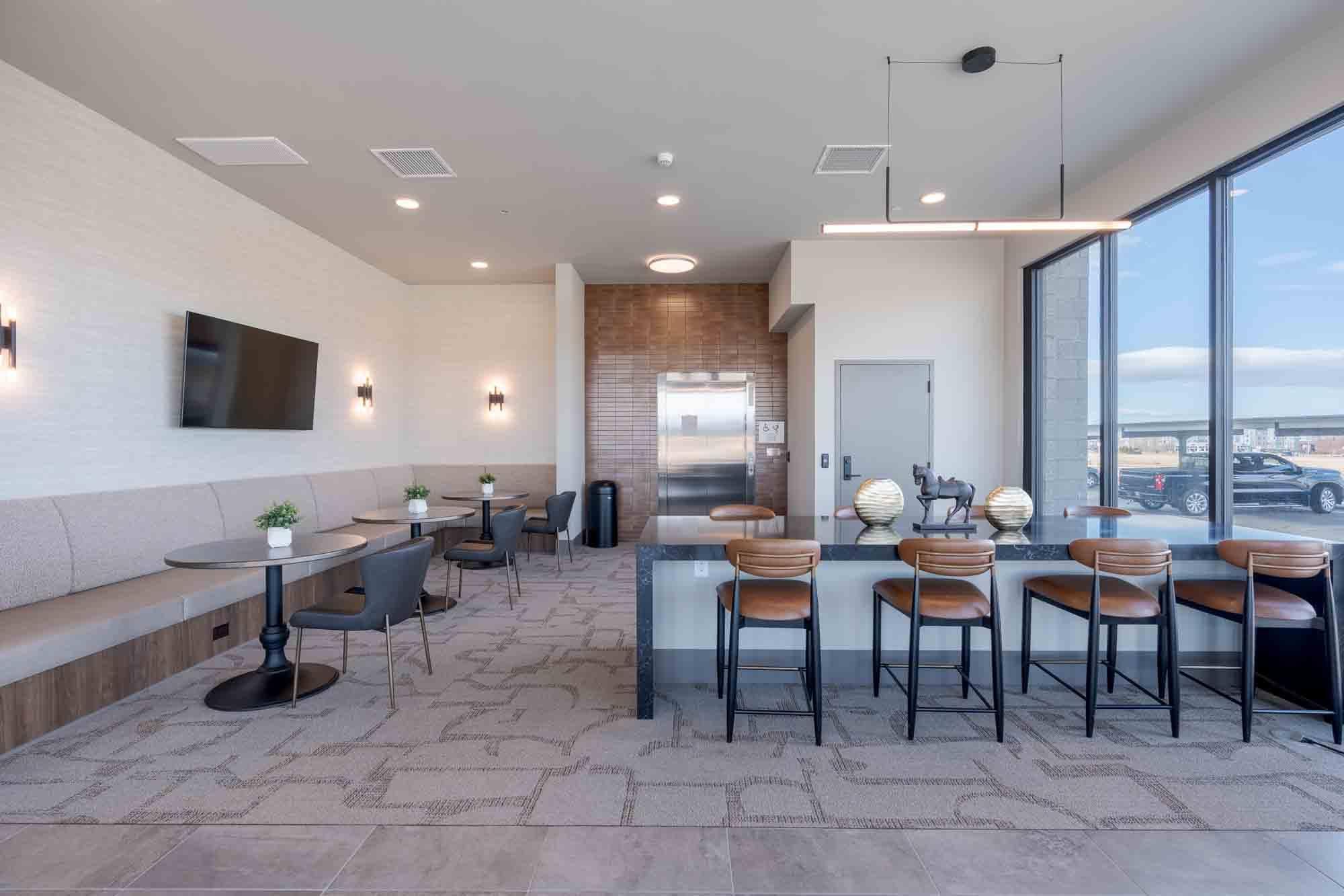 A modern dining area with a long table and chairs.