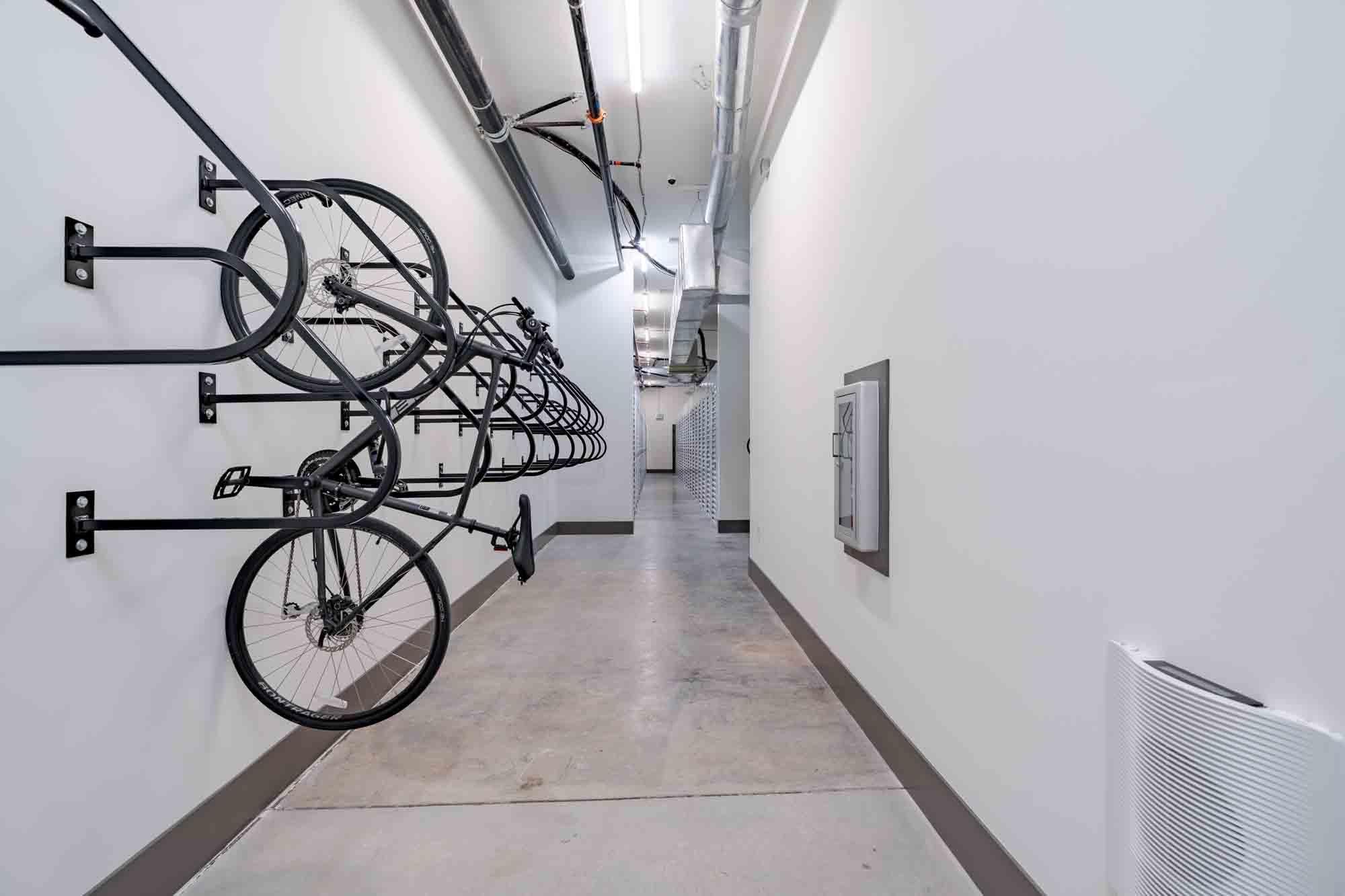 A hallway with bicycles hanging on the wall.
