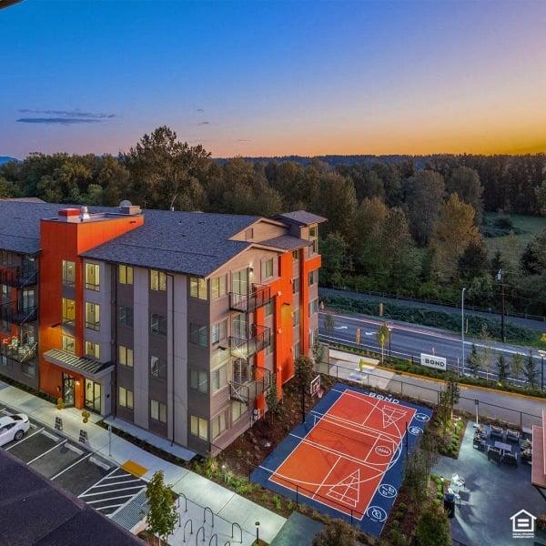 an aerial view of an apartment building with a basketball court