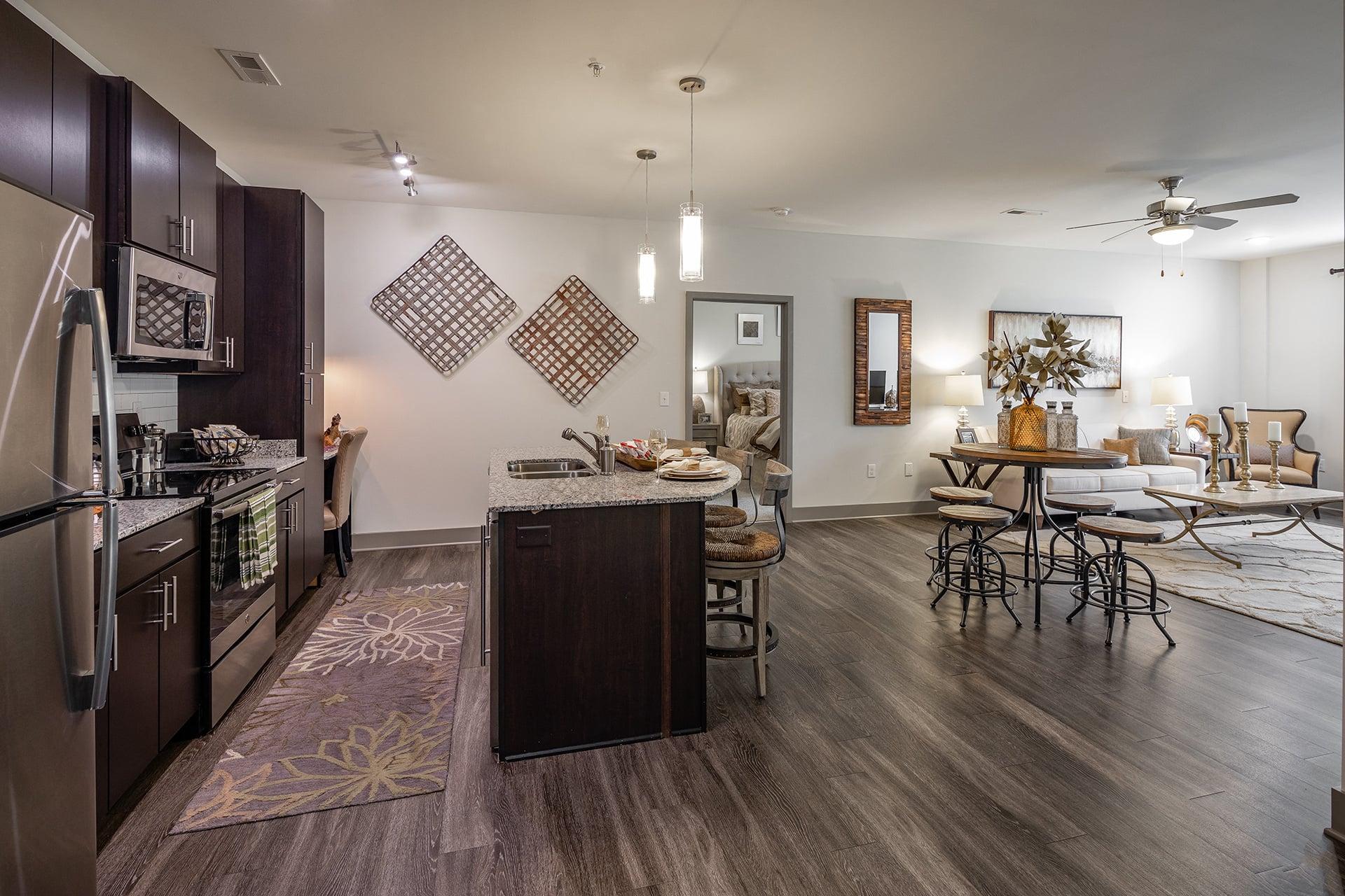 a kitchen and living room with a dining area and a table with chairs