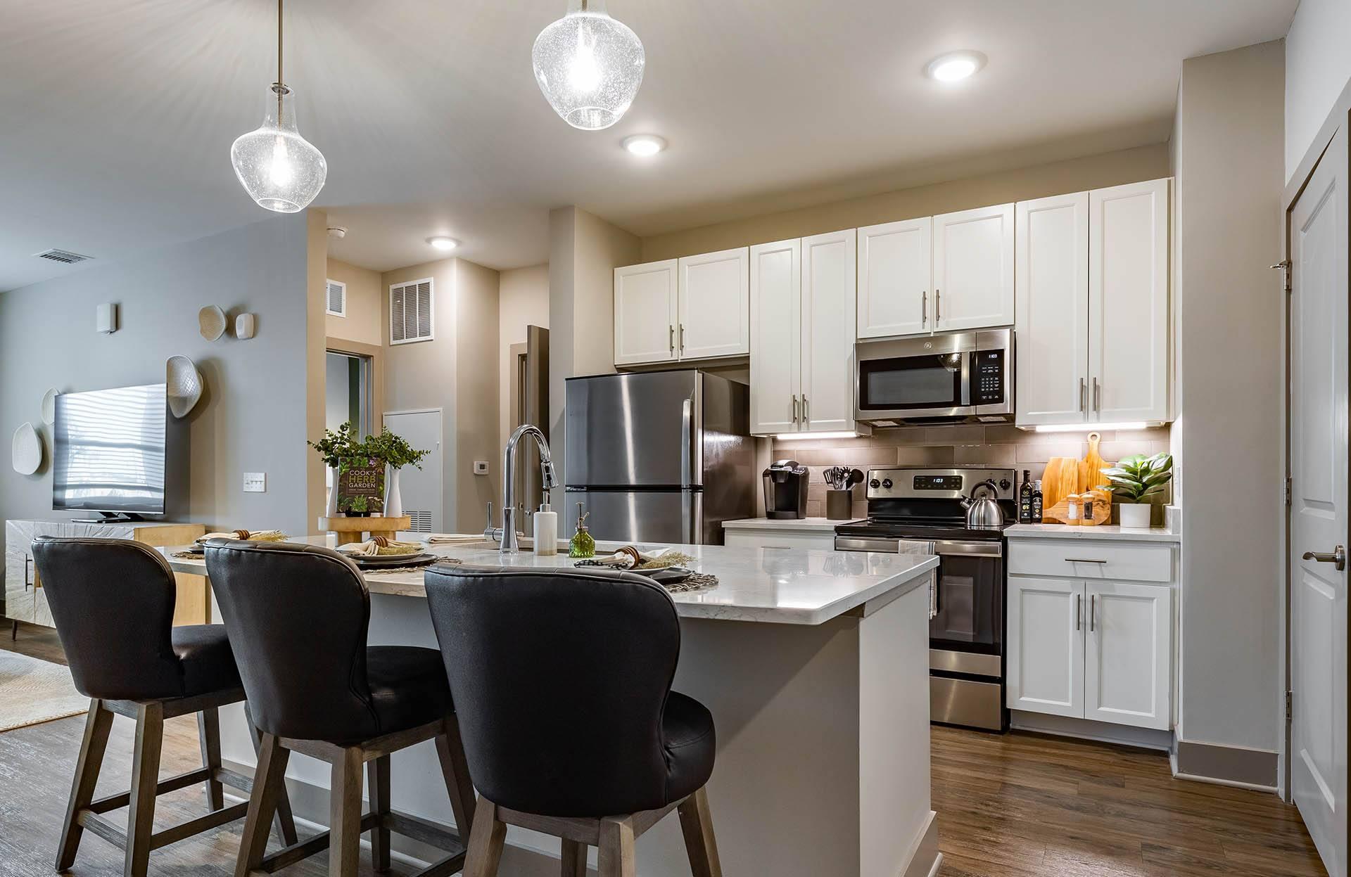 A modern kitchen with a dining table and chairs.