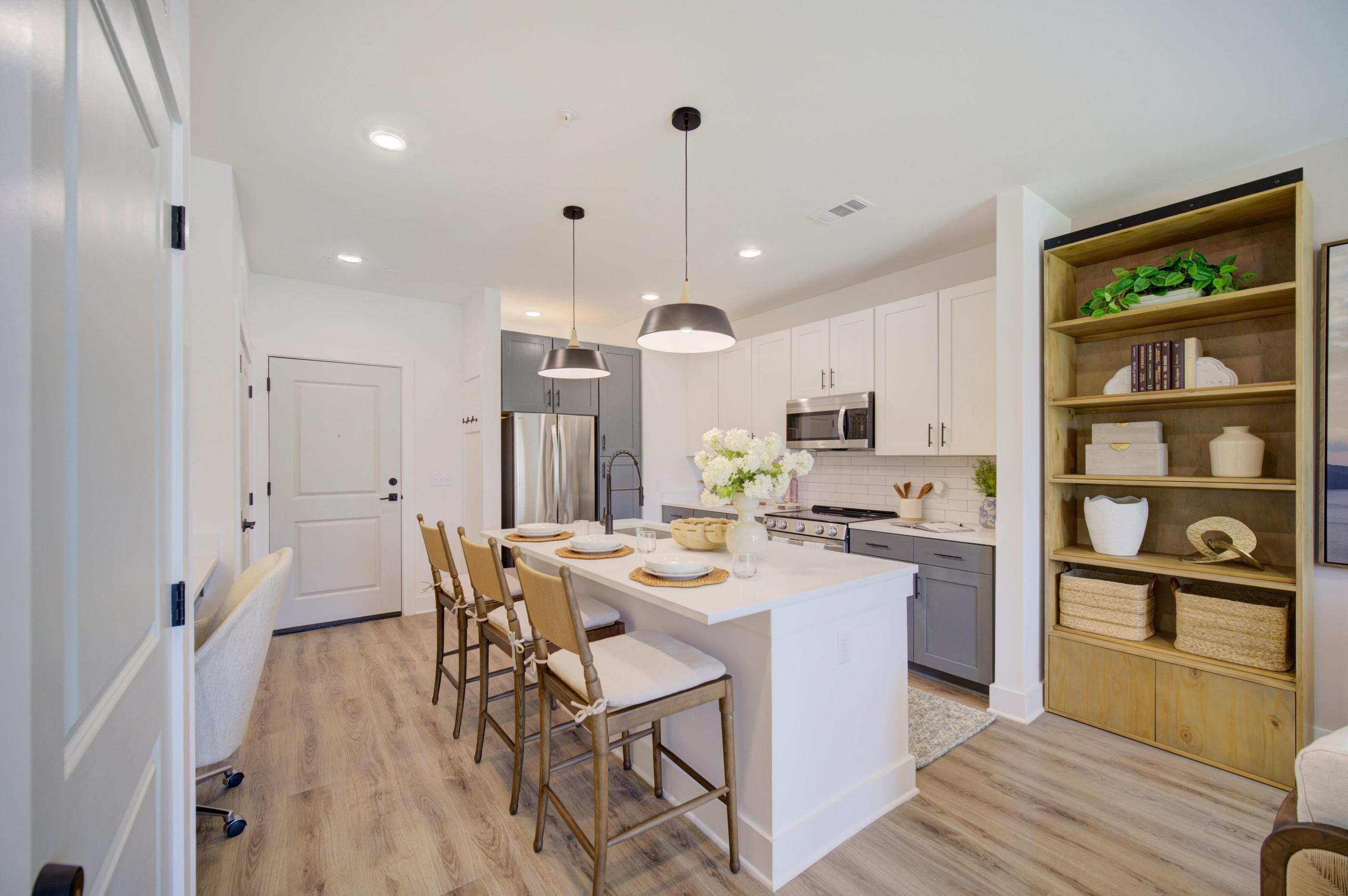A modern kitchen with a dining table and chairs.