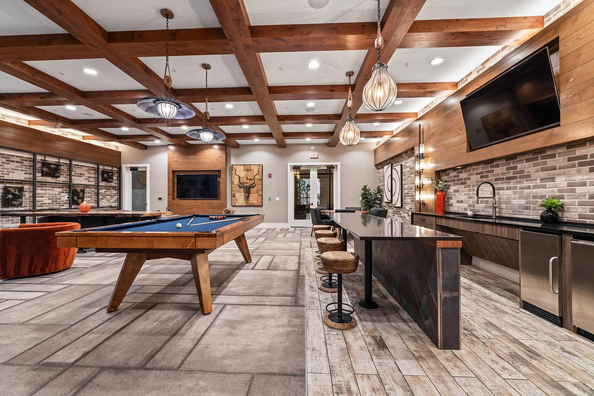 a game room with a pool table and a tv