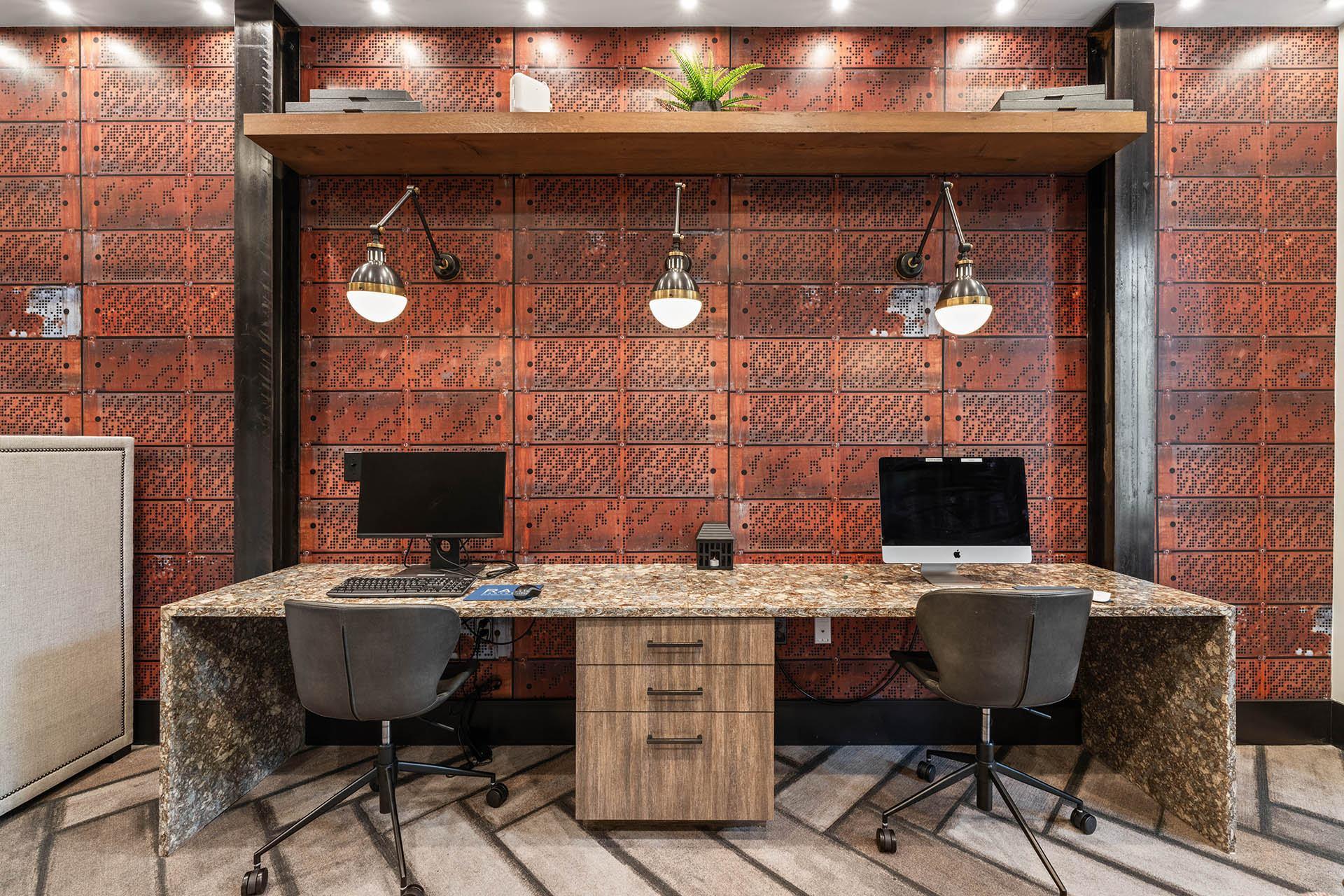 an office with a desk and two computers