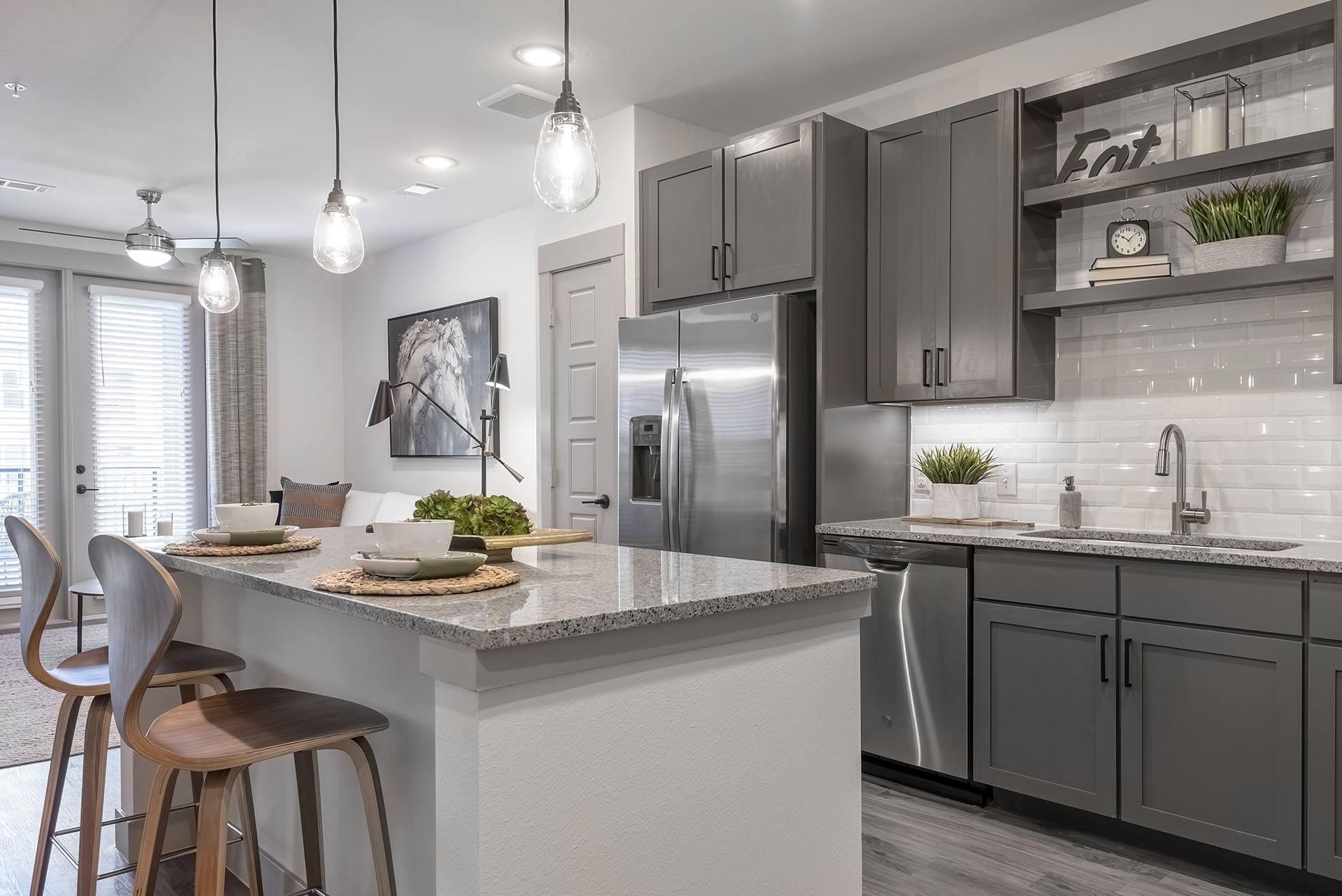 A modern kitchen with a dining table and chairs.