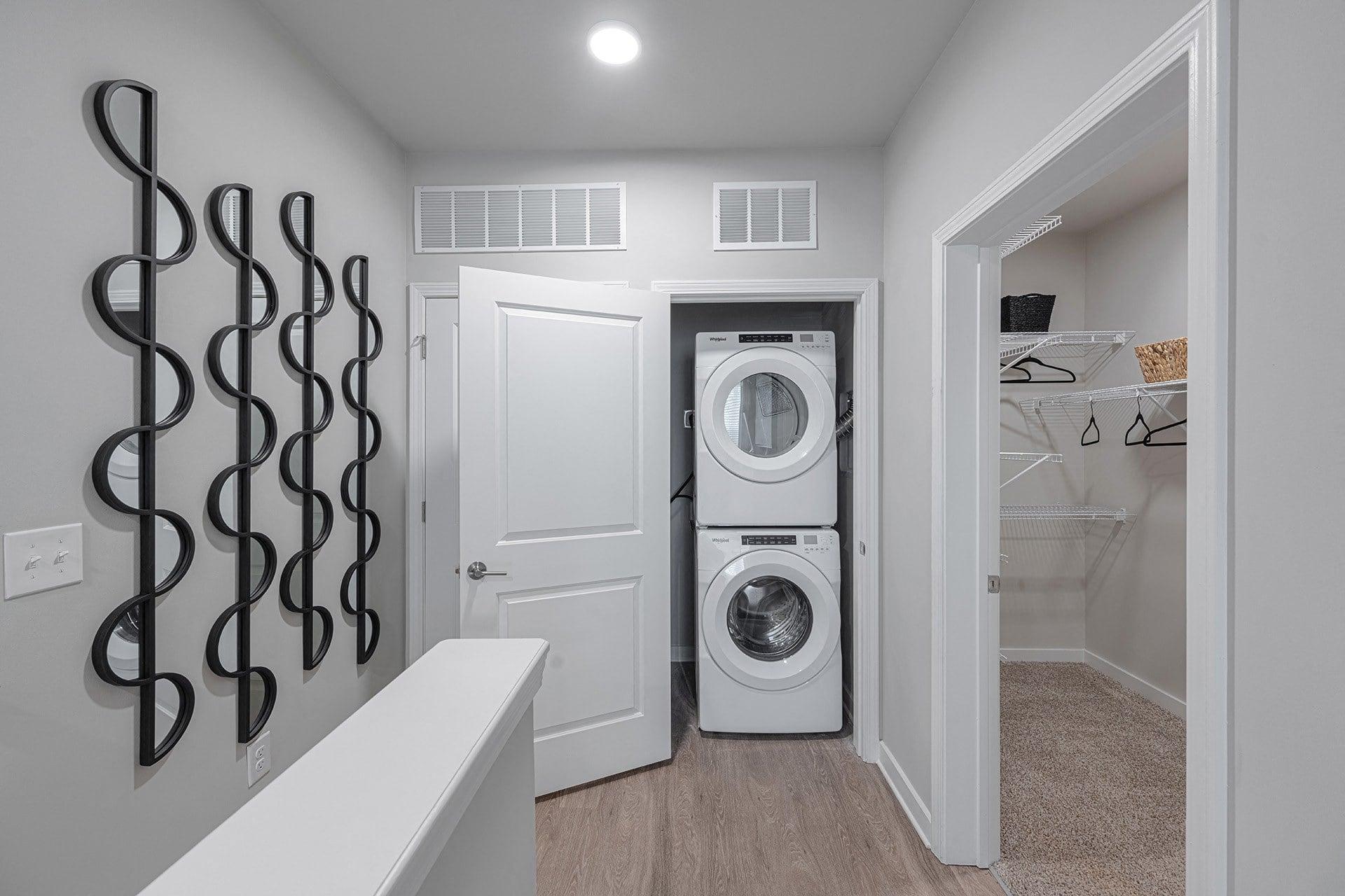 a washer and dryer in a laundry room with a white door