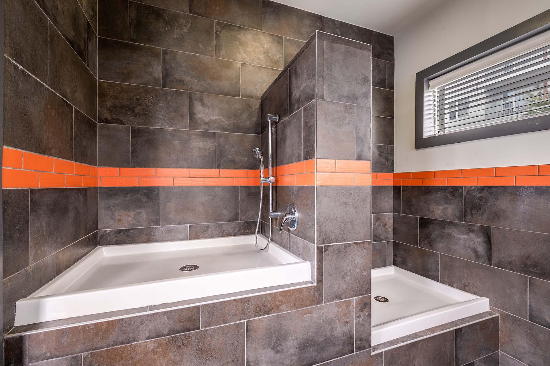 A bathroom with a white tub and a shower head.