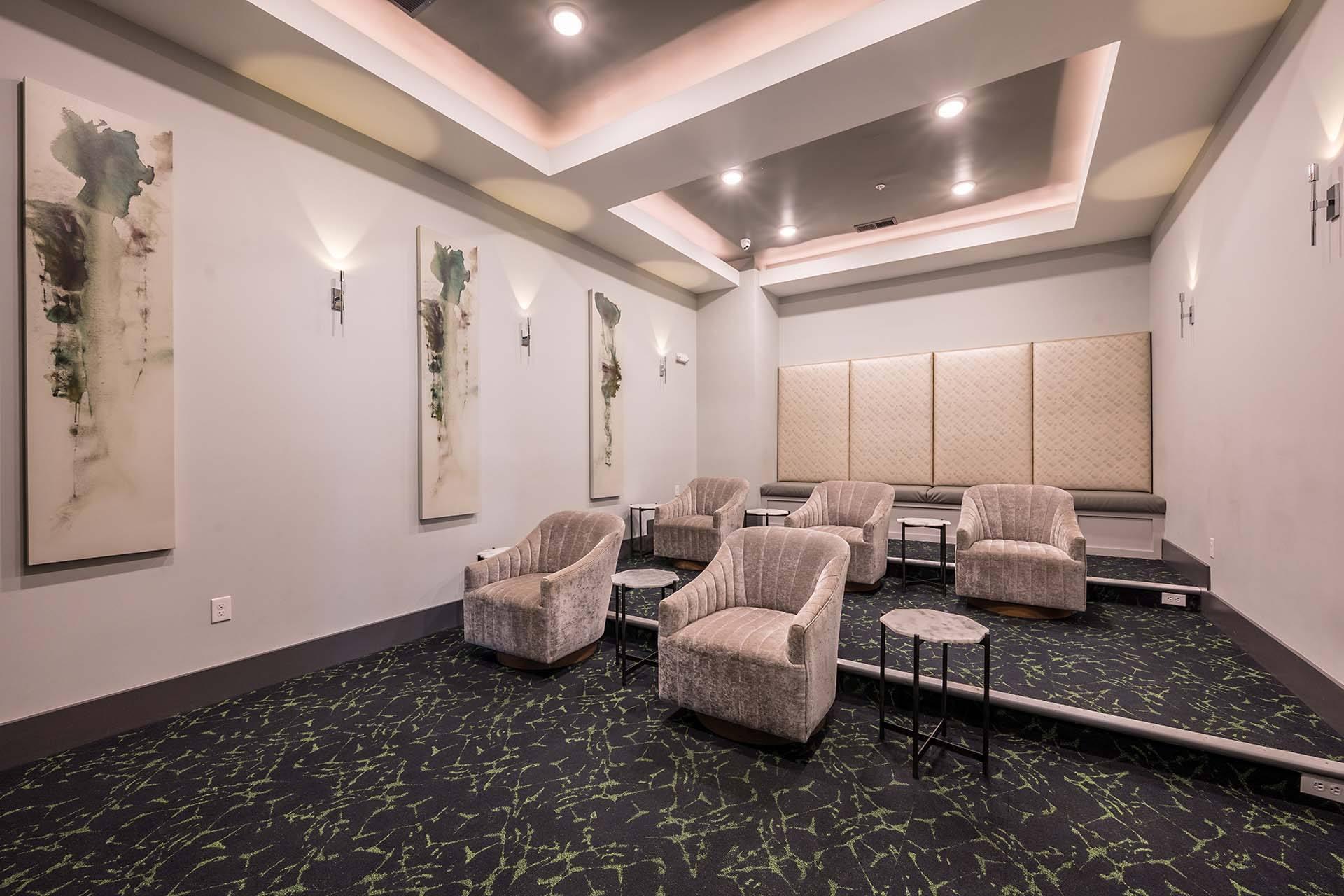 A room with a carpet and chairs.