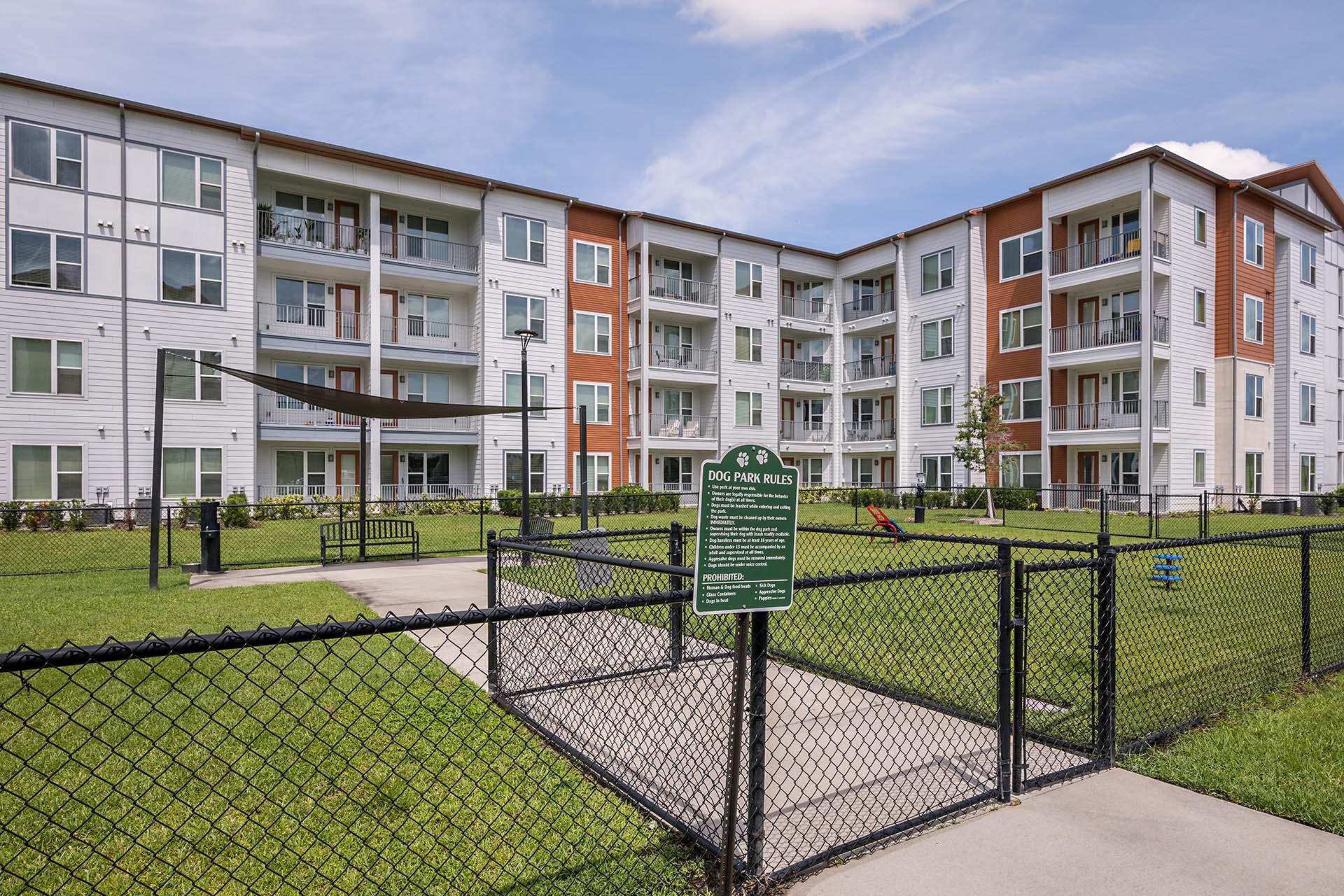 Apartment complex with a sign in front of it.