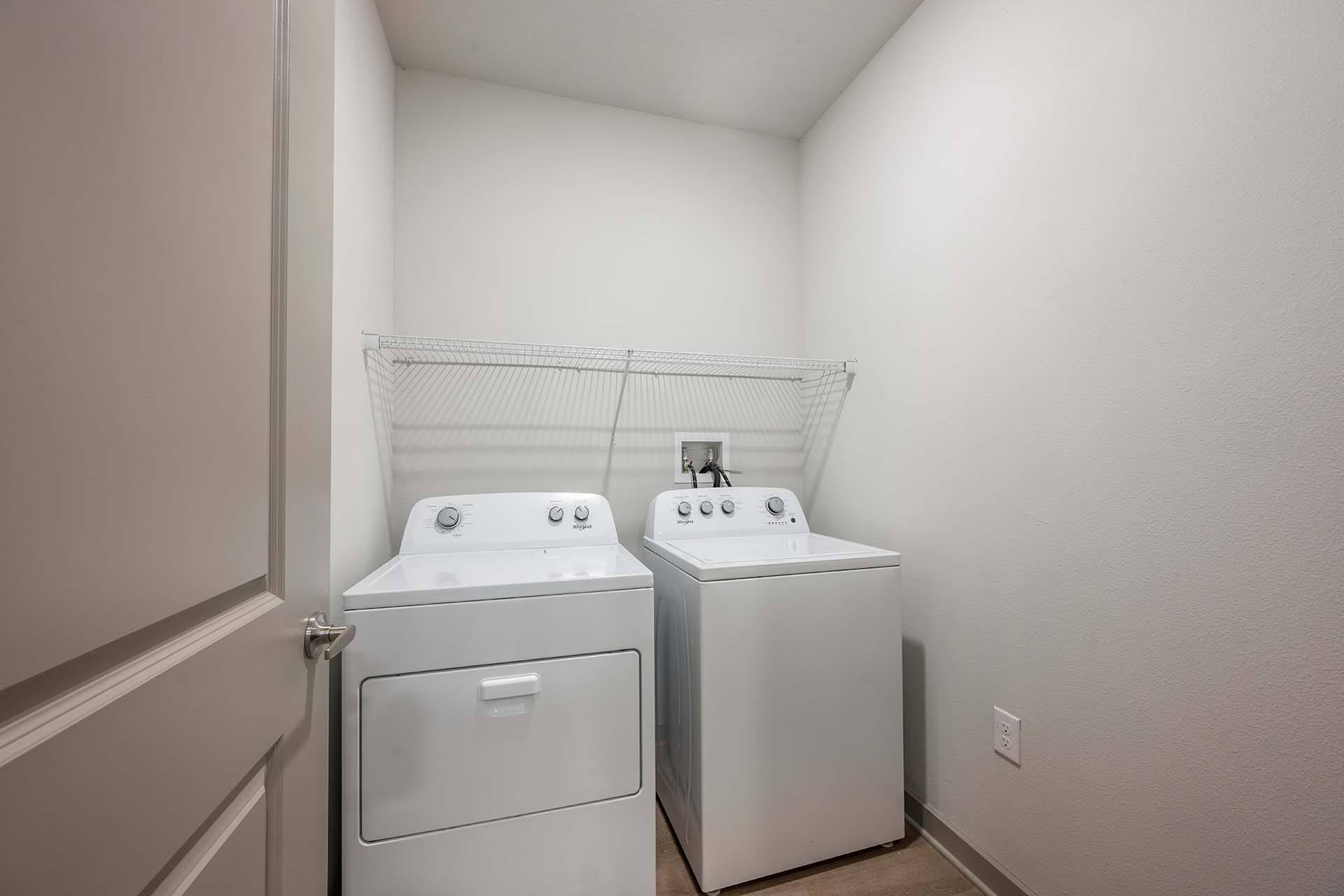 A laundry room with two washing machines.