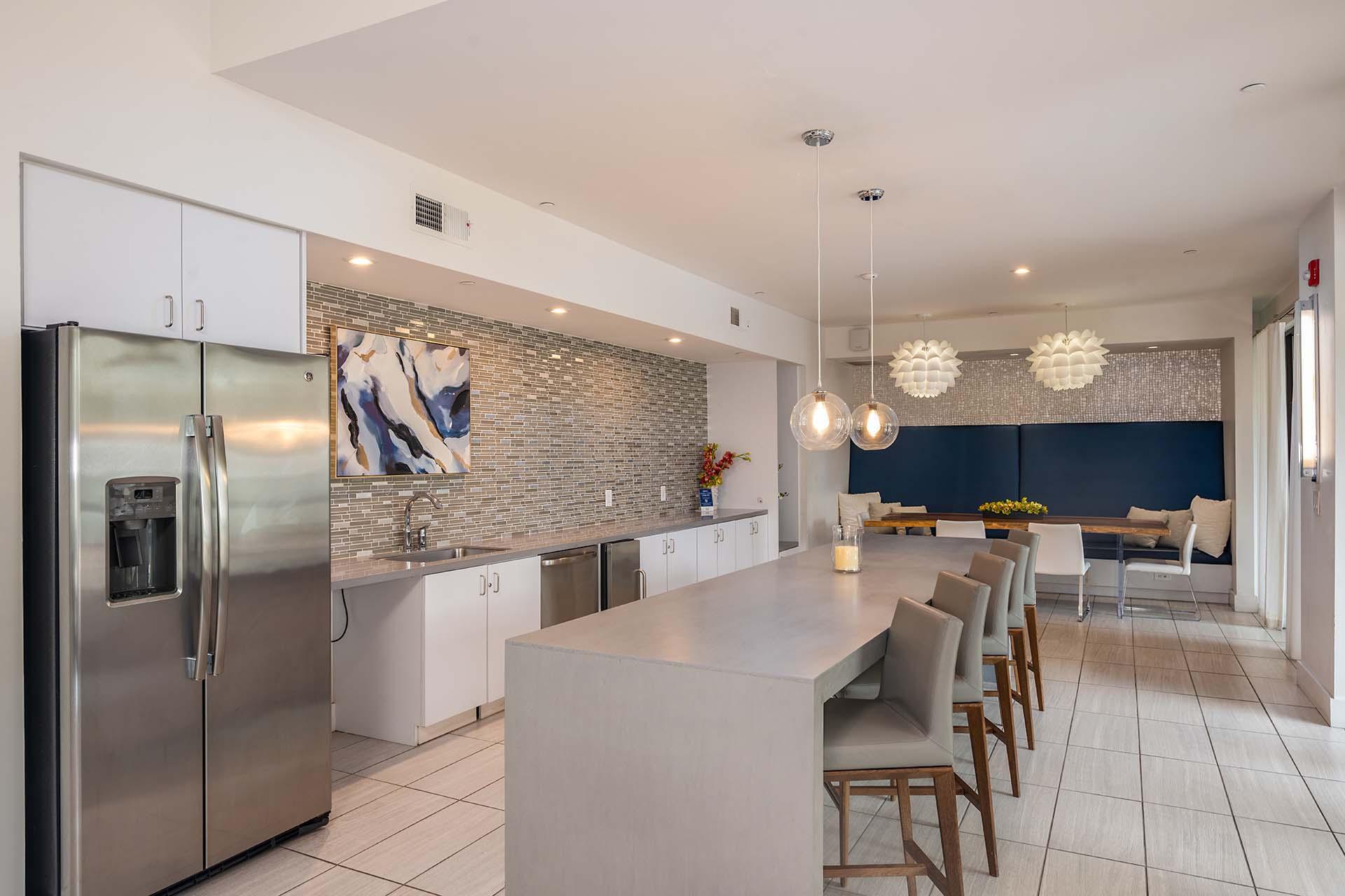 A modern kitchen with a large island and stainless steel appliances.
