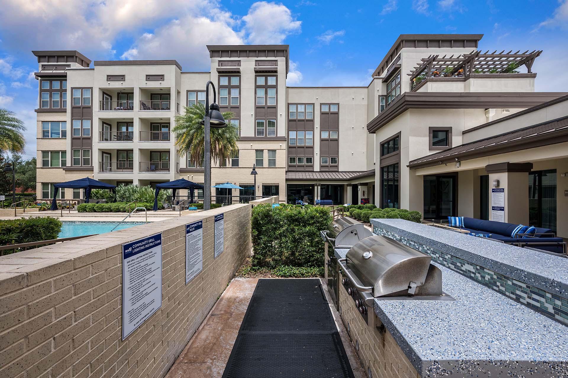 A building with a pool and a walkway with signs on it.