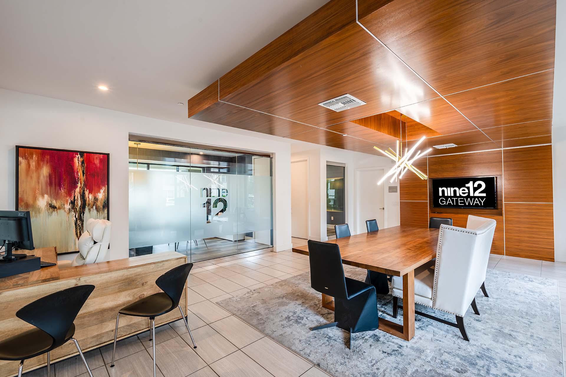 A conference room with a long table and chairs.